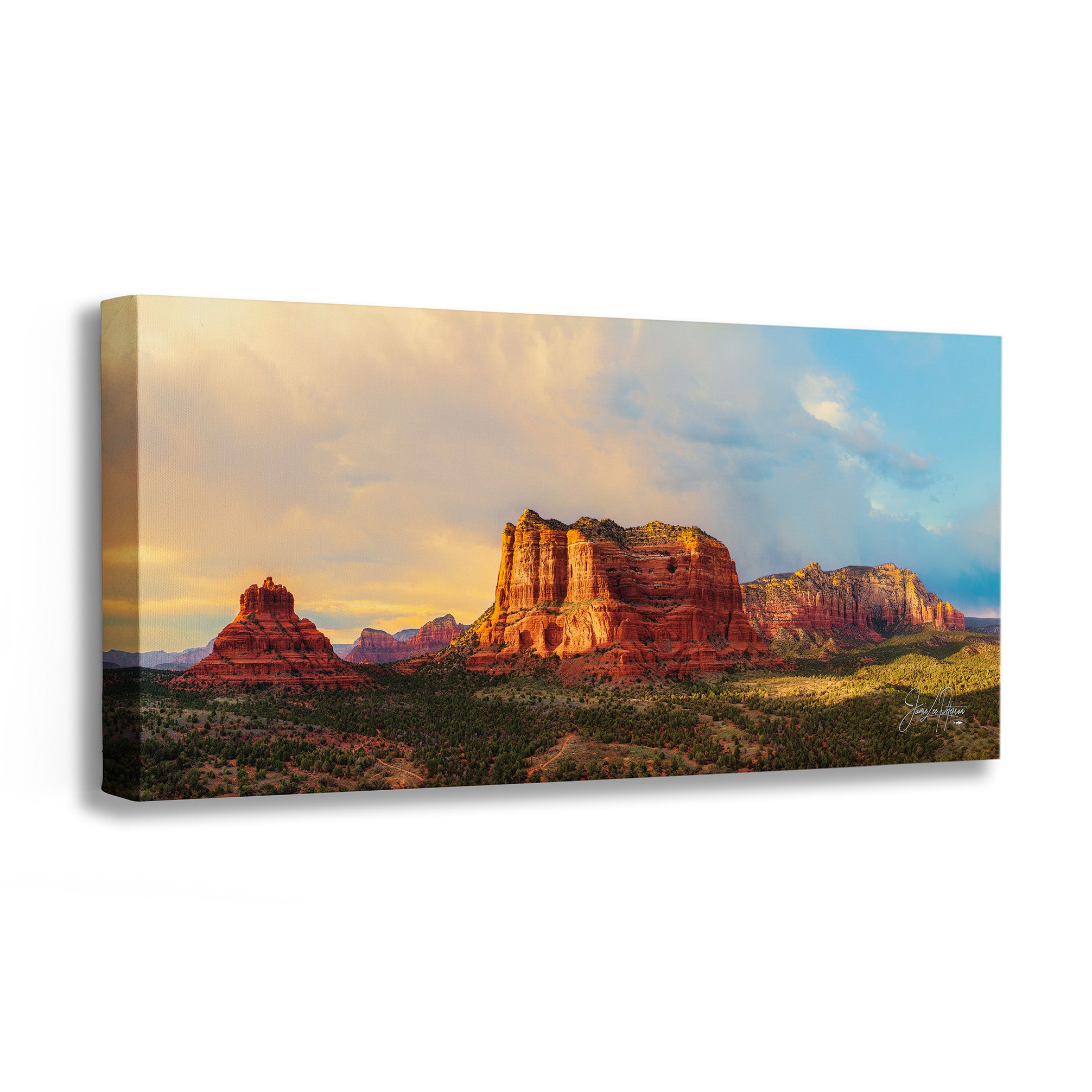 Canvas print of a desert landscape with red rock formations and a sunset sky.
