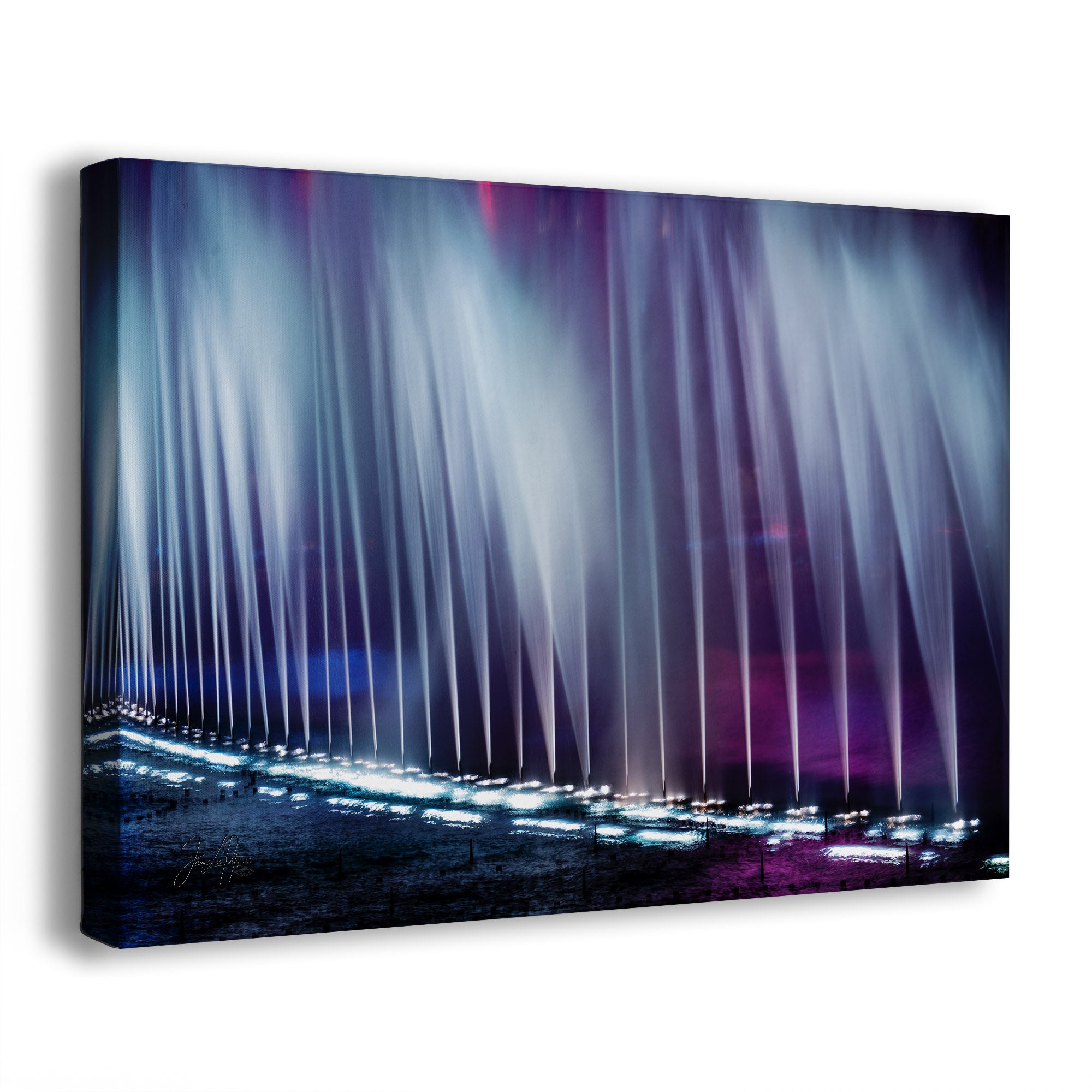An abstract fountain wall art canvas showing a nighttime scene from the Bellagio fountains in Las Vegas, Nevada, with vertical light jets in blue, purple, and white over a dark ground, photographed against a clean white background.
