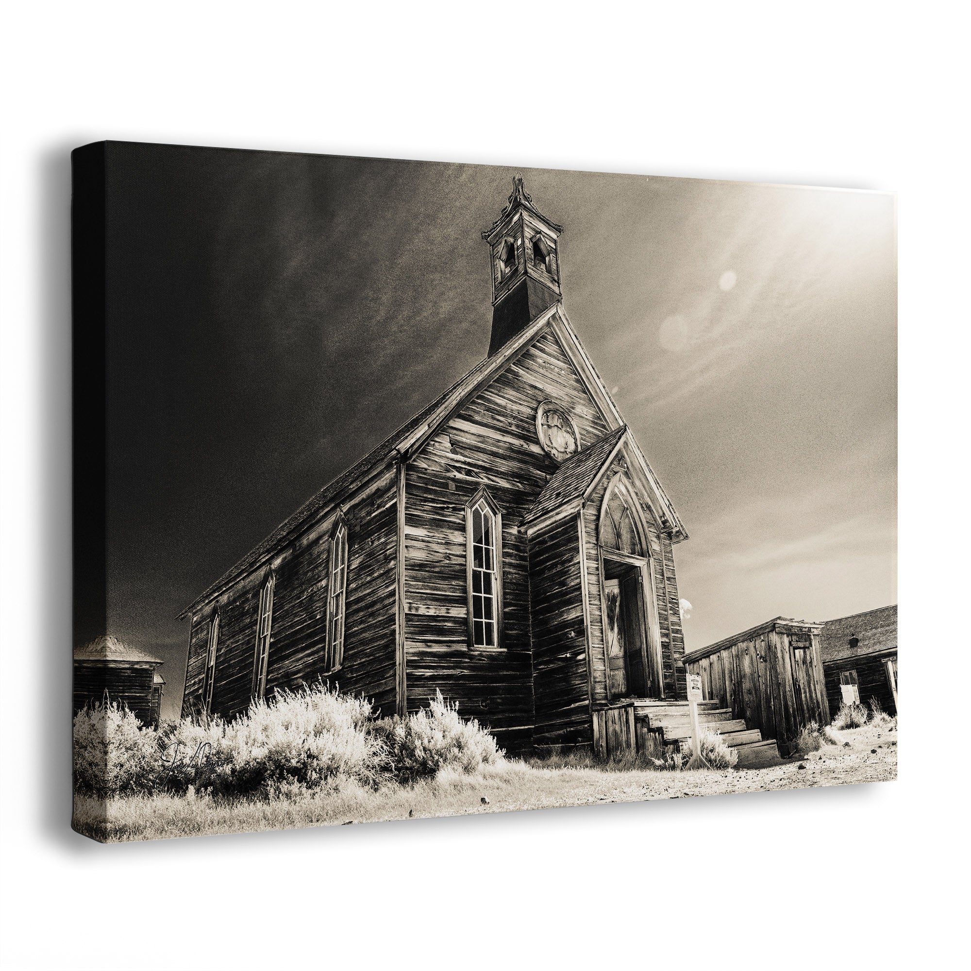 A rectangular wall art canvas showing a sepia-toned photograph of an old wooden church building with a steeple from Bodie Ghost Town in California, photographed against a plain white background.