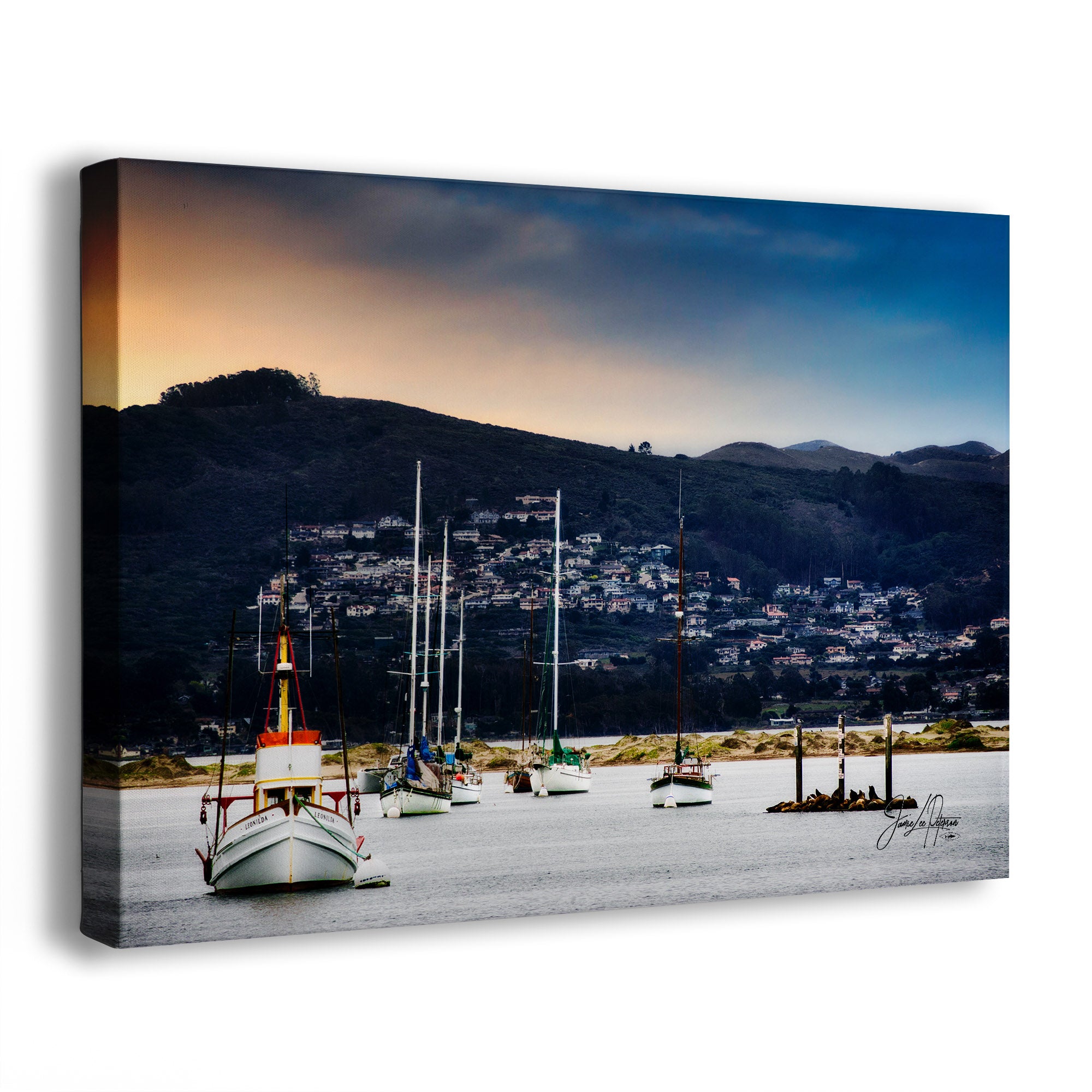 Canvas print of boats docked at a harbor with mountains in the background