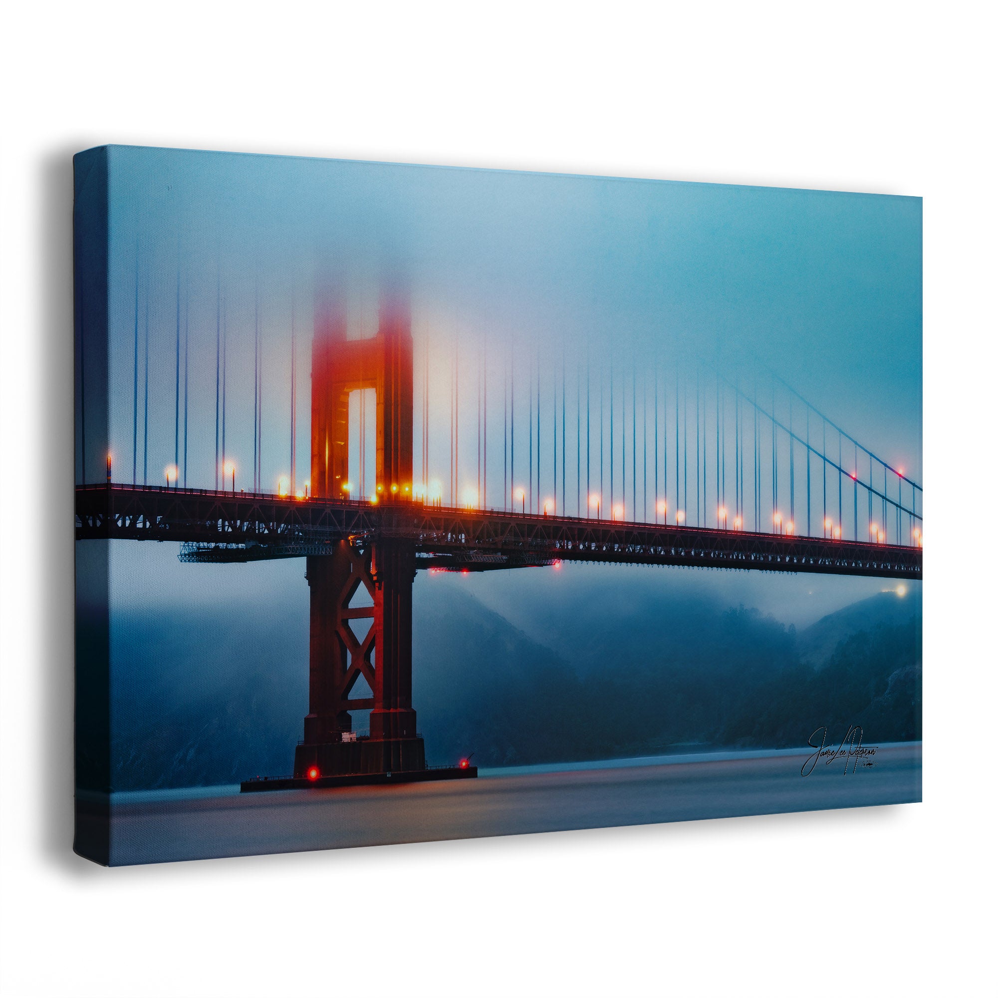 A blue foggy canvas print of the Golden Gate Bridge at night with lights on
