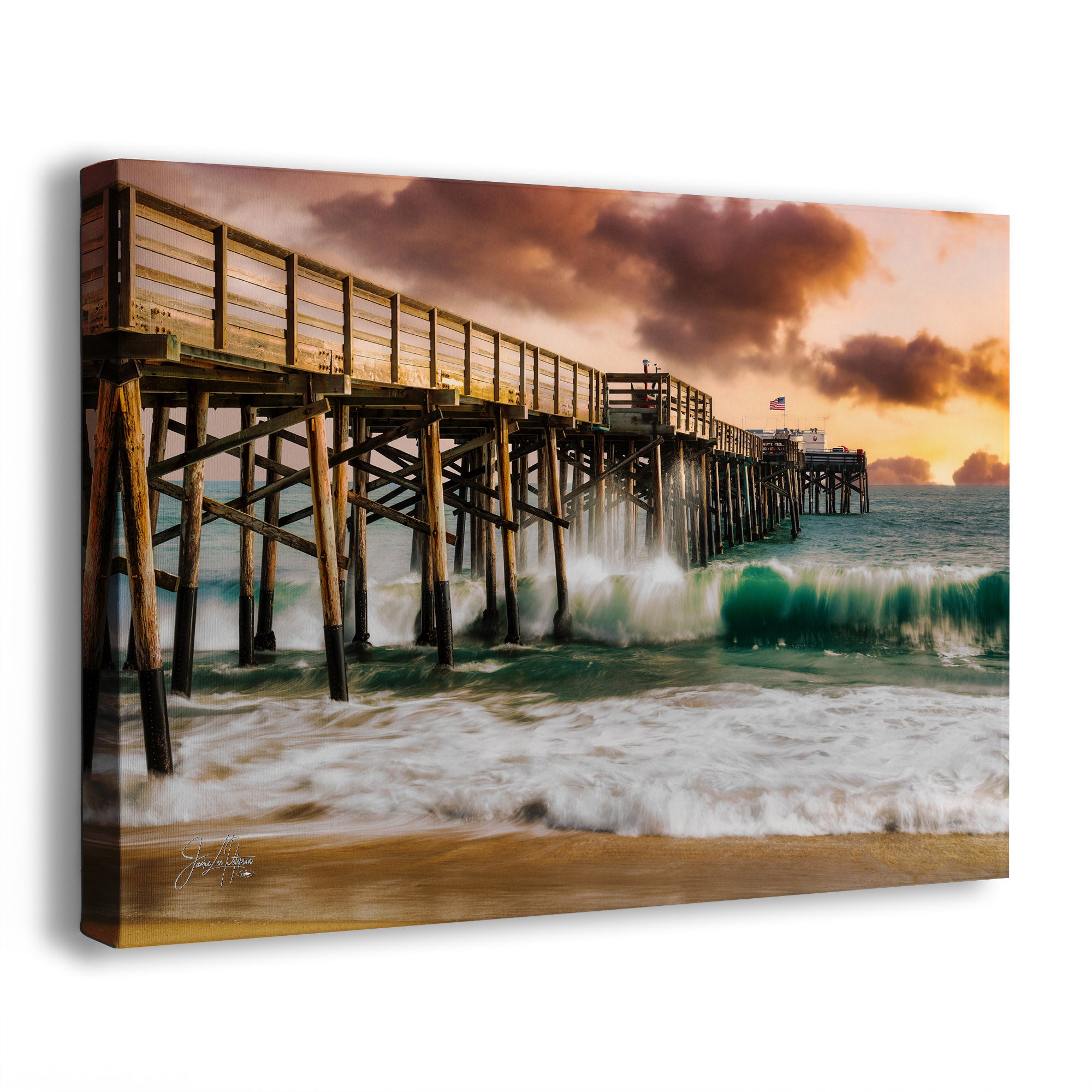 A canvas wall art picture of Newport Beach, California's wooden Balboa Pier with waves crashing against it during sunset.