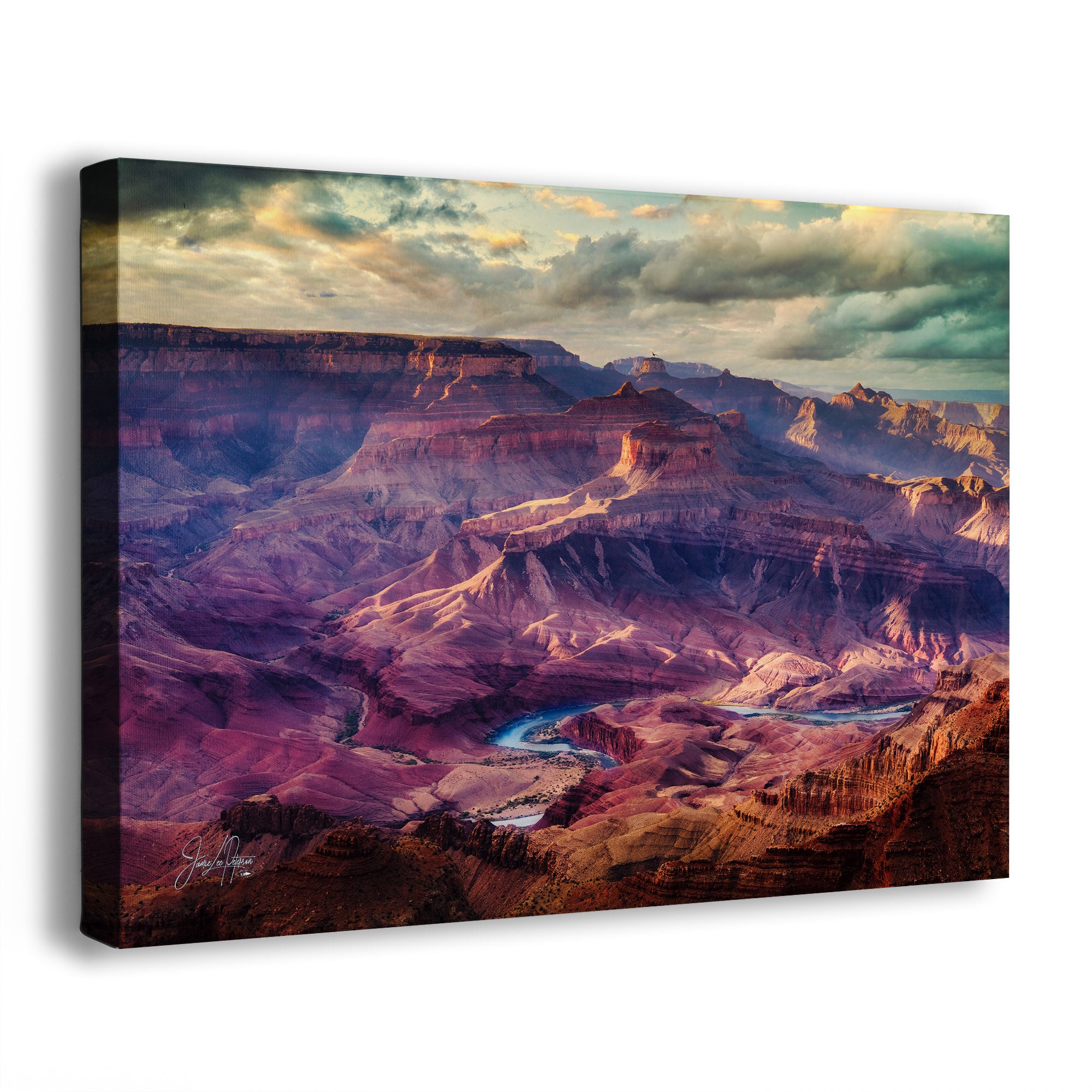 A side view of a canvas wall art print of the Grand Canyon with a colorful landscape and the Colorado River winding through it.