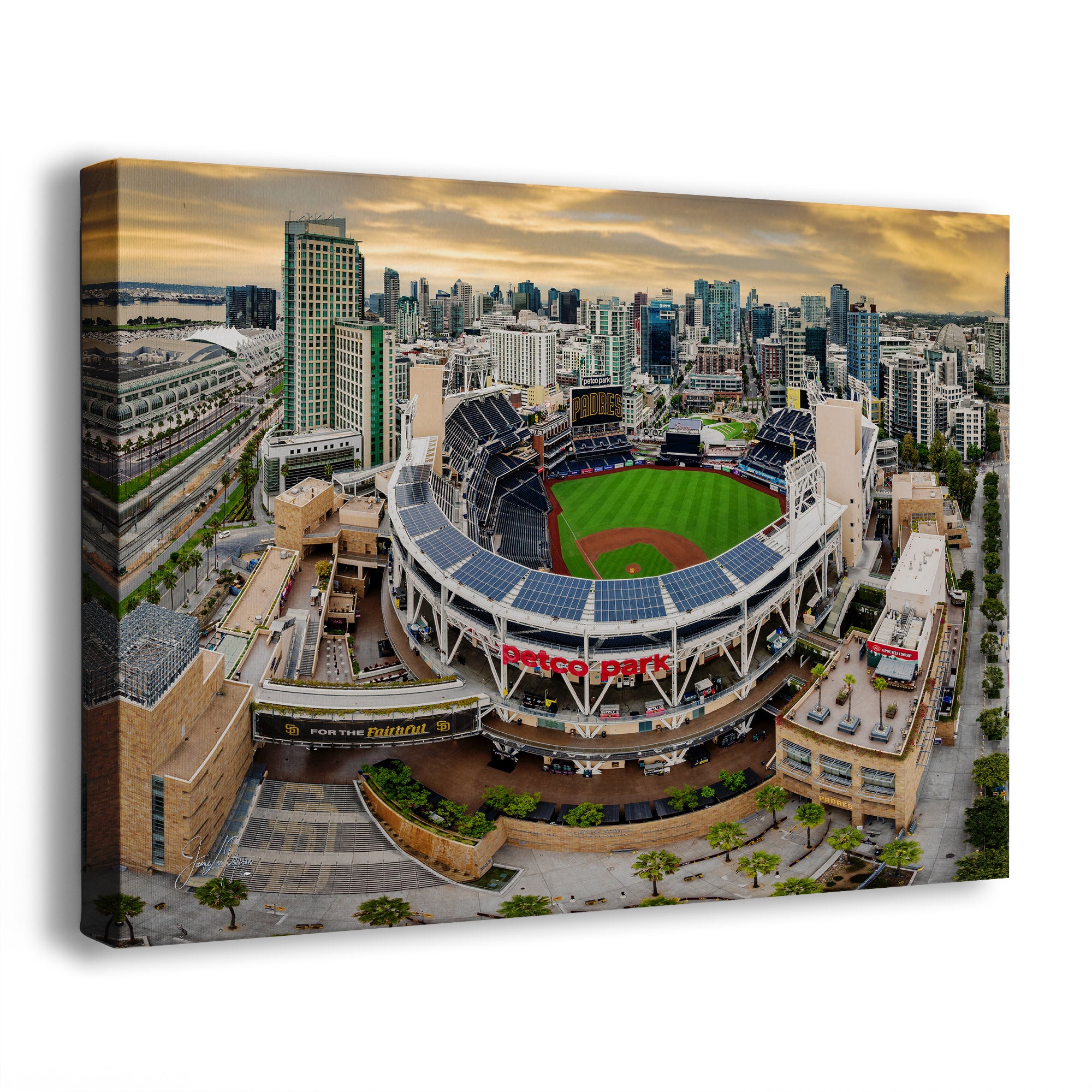 A rectangular wall art print showing an aerial view of a the Padres Petco Park baseball stadium with the San Diego skyline at sunset, displayed at an angle on a white background.
