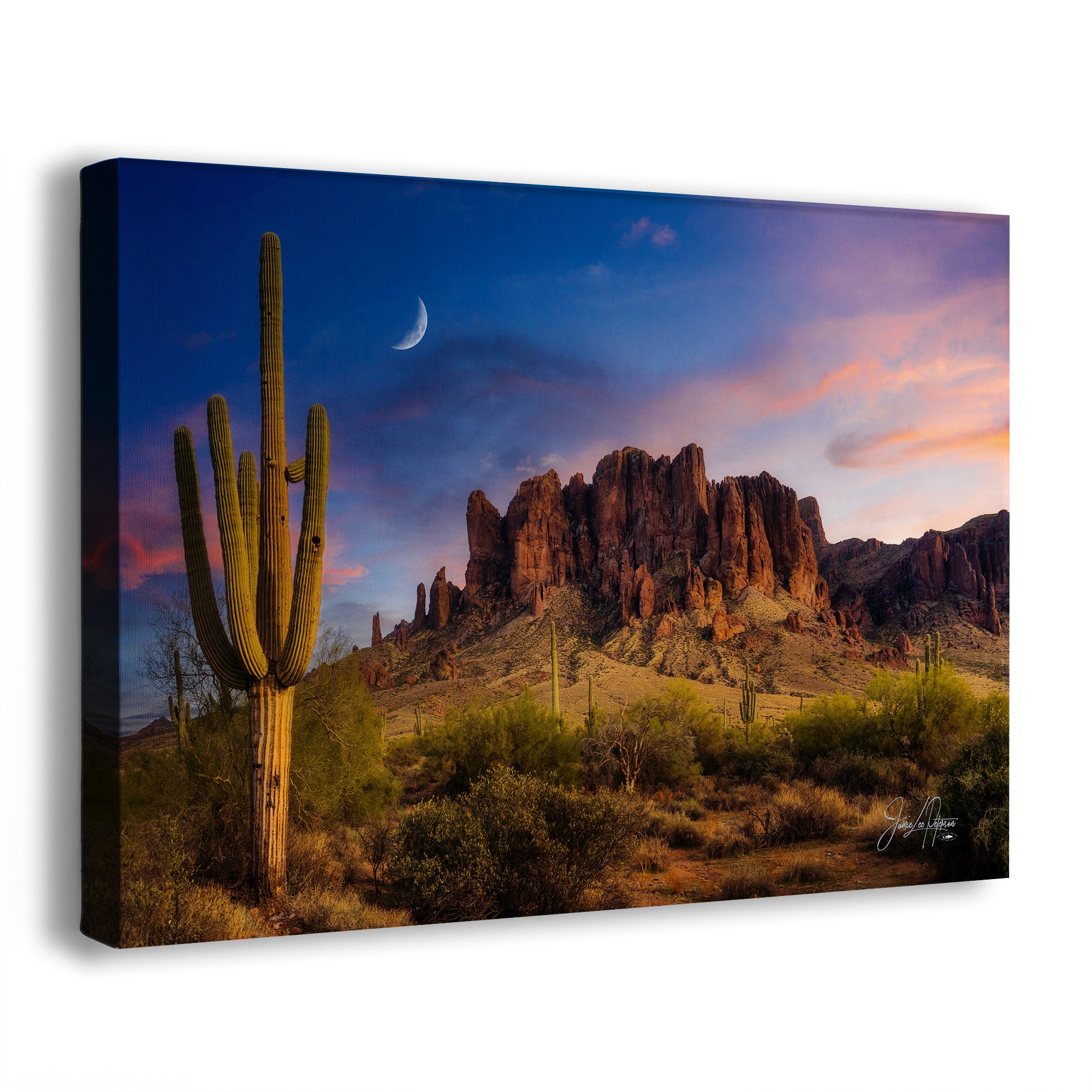 A canvas wall art print of the Lost Dutchman desert landscape of the Superstition Mountains with Saguaro cactus and rock formations under a colorful sky.