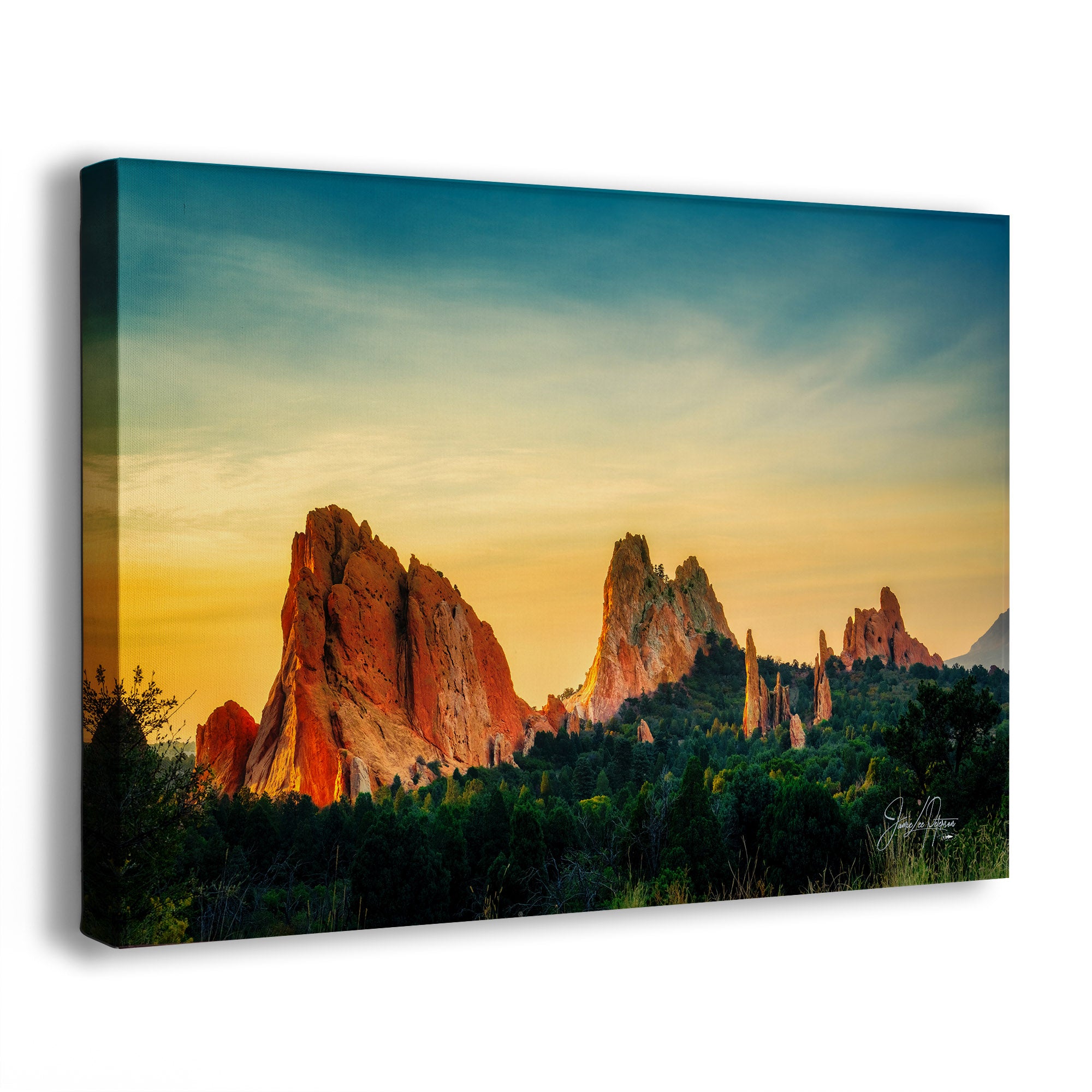 A canvas wall art print from Garden of the Gods, Colorado, showing a dramatic desert rock formation landscape at sunrise, photographed against a plain white background with a slight shadow.