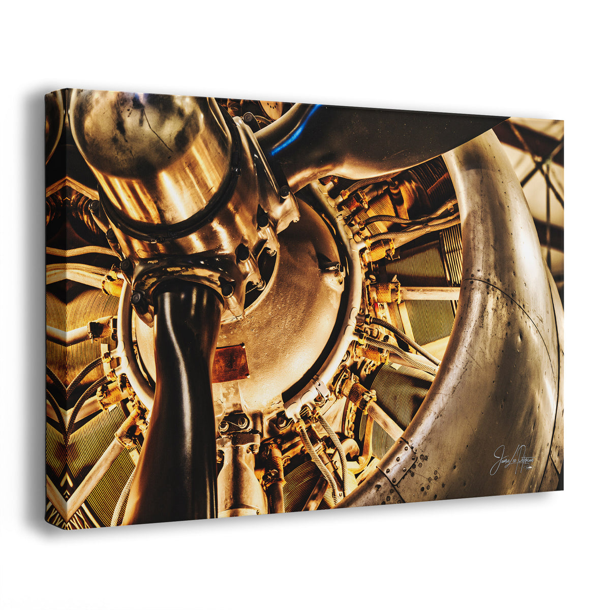 A vintage airplane engine wall art canvas print of a Studebaker engine, in warm gold, bronze, and dark gray tones, photographed at an angle against a light gray background.