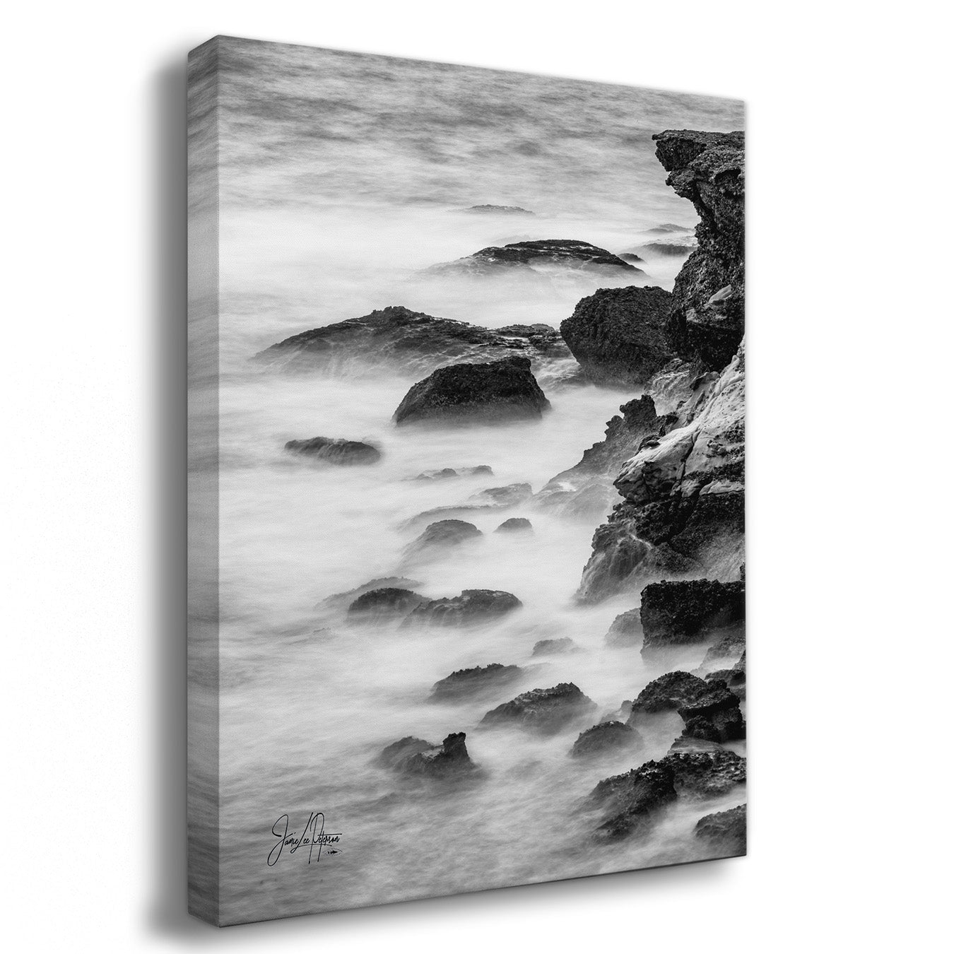 Canvas print of a black and white coastal scene with rocks and water.