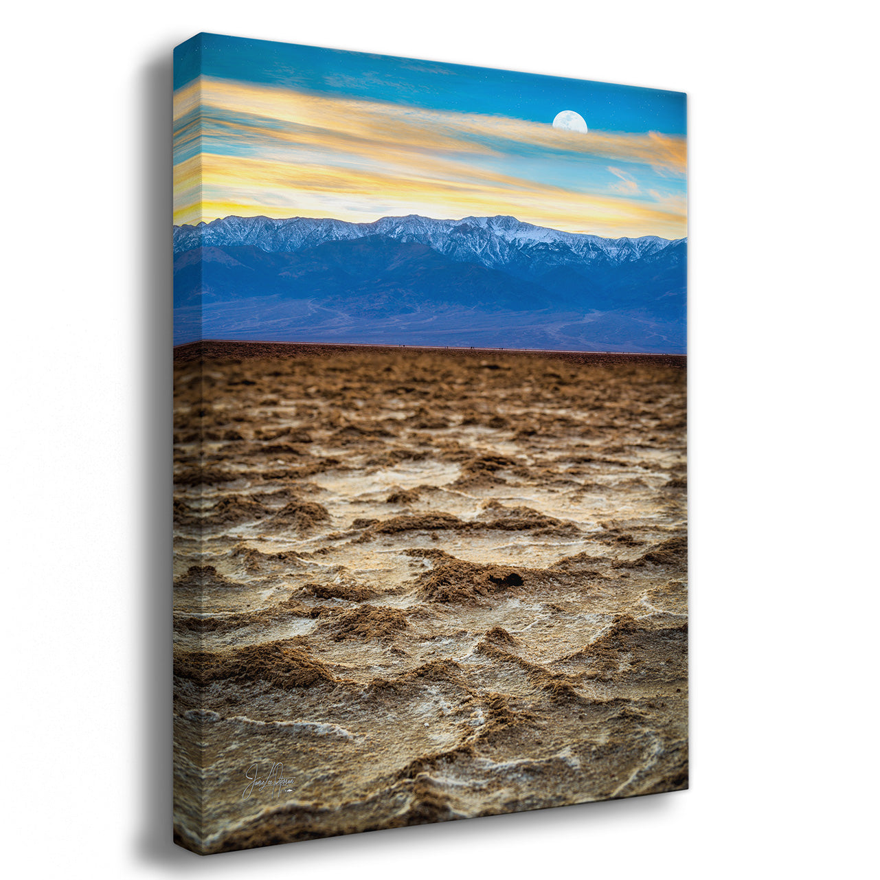 Canvas print of a desert landscape with mountains and a blue sky.