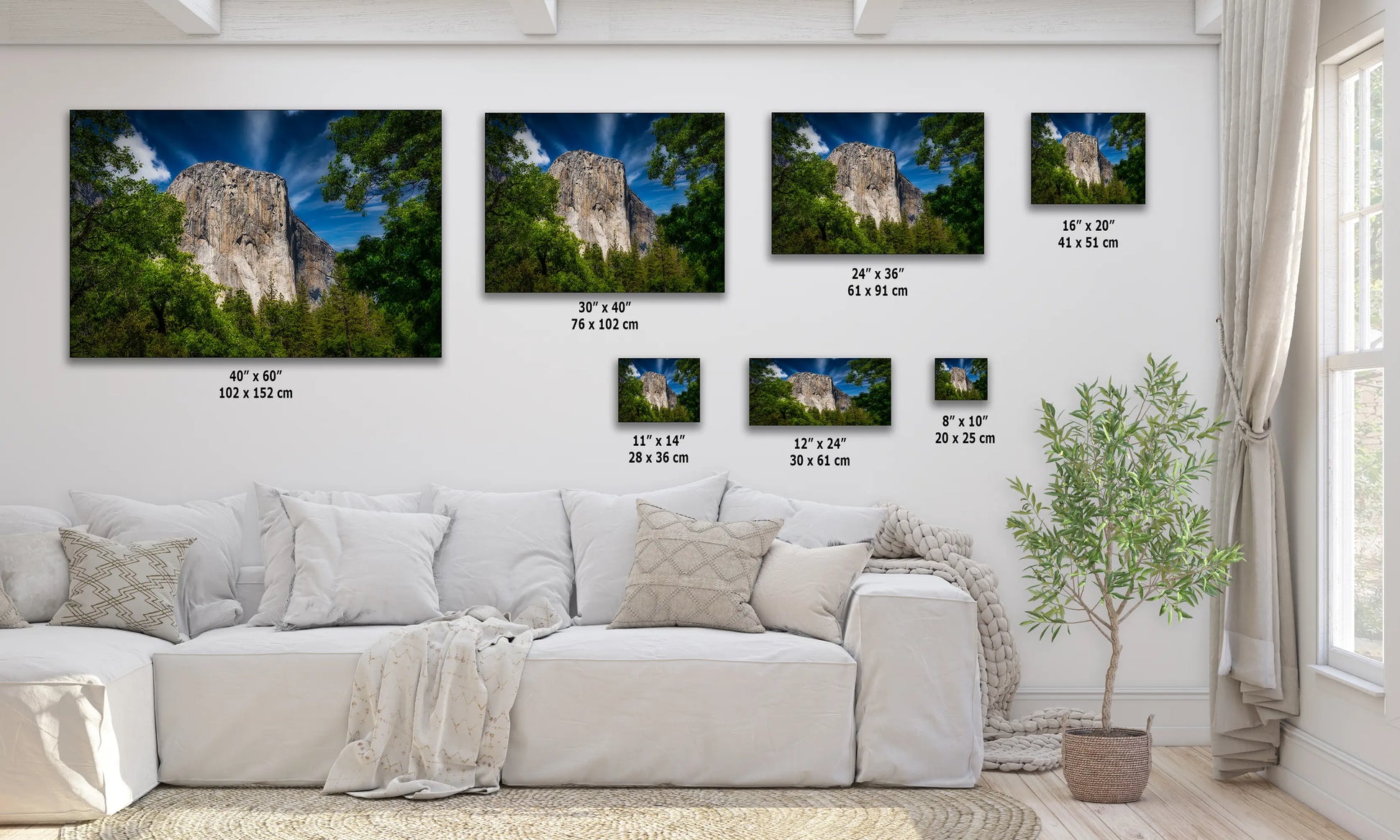 a living room with a white couch and three pictures on the wall