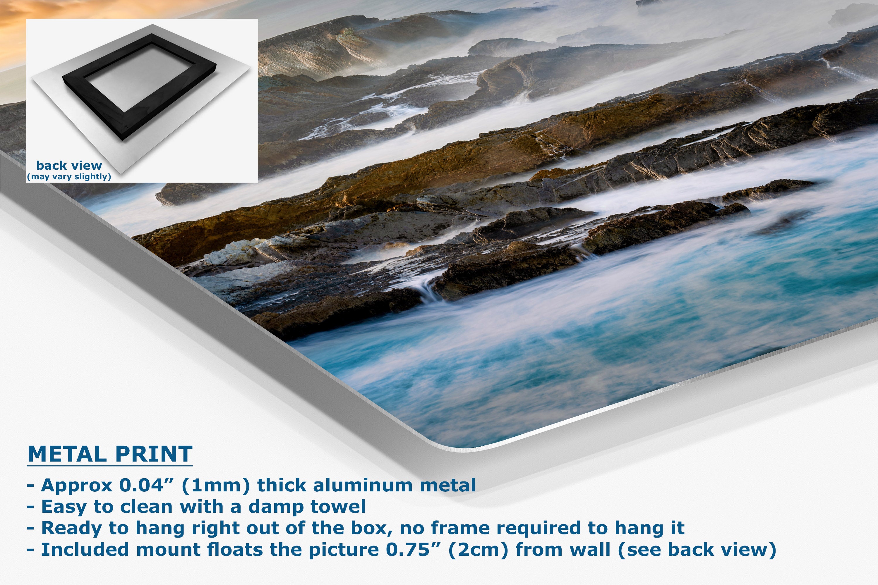 A metal wall art print showing a coastal landscape with rocky cliffs and turquoise water, presented at an angle with product text and a small back-view inset. The text highlights the aluminum metal finish and mounting details.