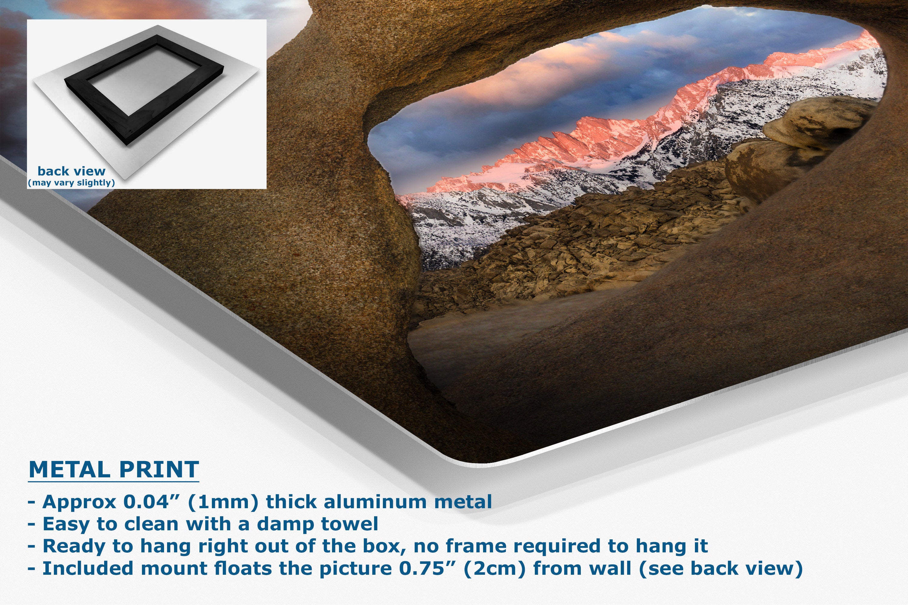 A metal wall art print showing a dramatic mountain landscape with snowy peaks under a pink and blue sky, displayed in a cave-like opening. The image includes a small inset showing the back view of the frame, plus text describing the metal art product.