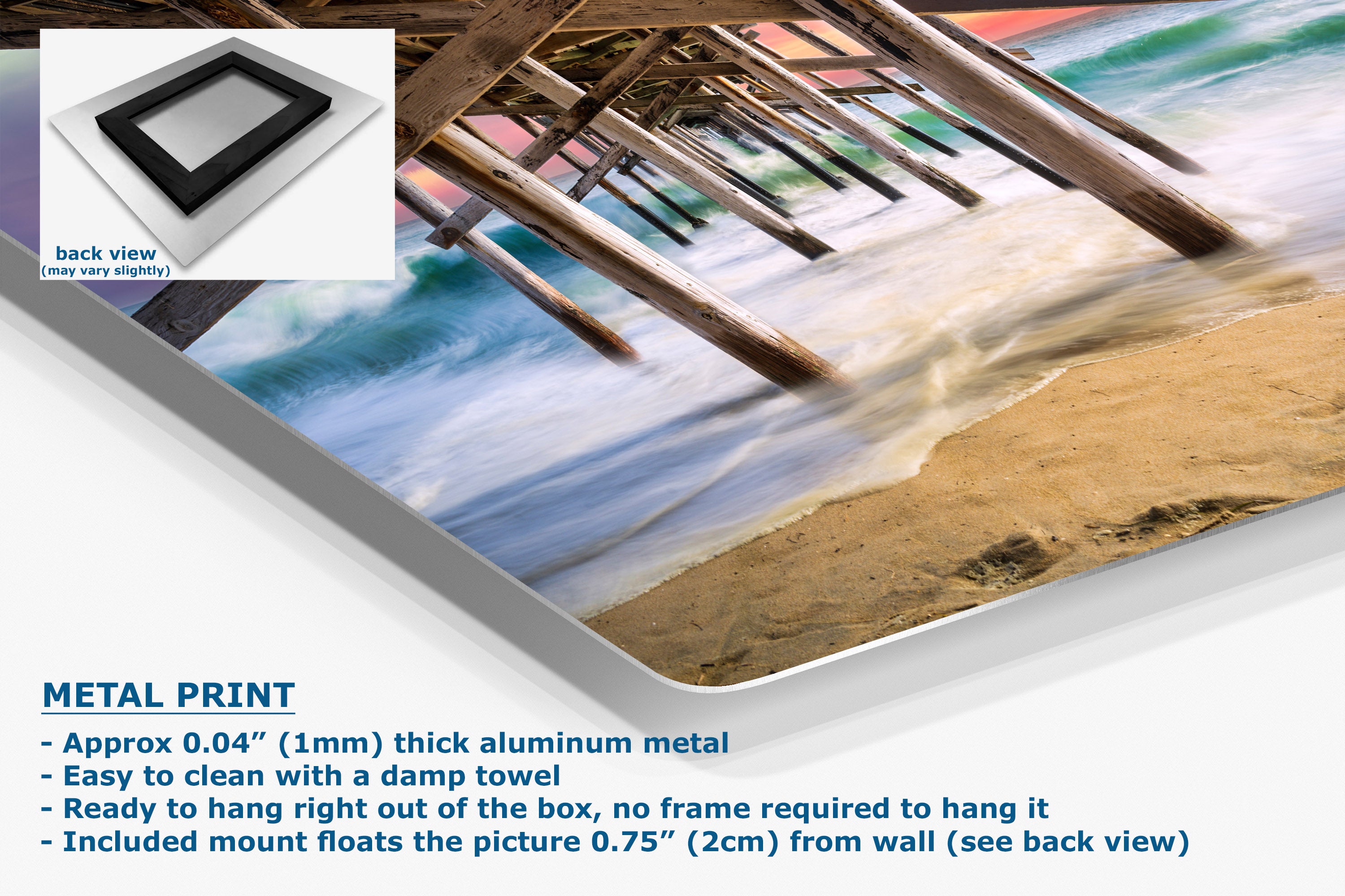 A corner of a metal wall art print showing a beach scene with wooden pier supports over the ocean, displayed at an angle with product details and text overlays on a white background.