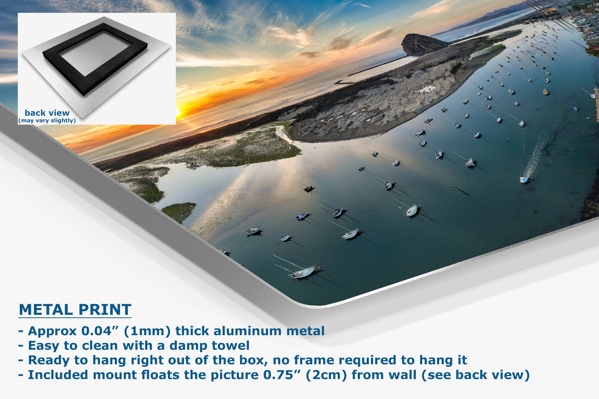 A metal print wall art panel shown at an angle with a scenic coastal harbor sunset image printed on it. The graphic includes a small back-view inset, text reading 'METAL PRINT,' and product details about the aluminum finish, clean mounting, and picture float.