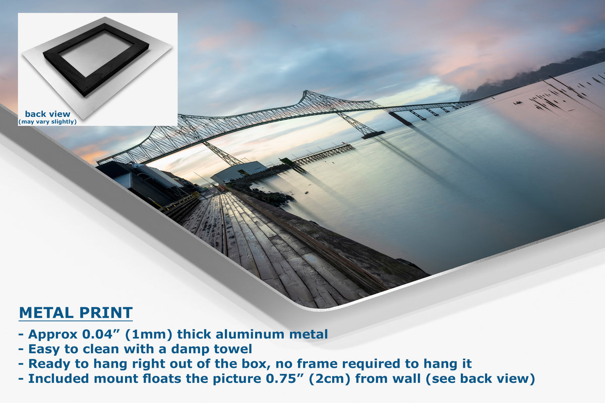 A metal wall art print showing a large bridge over water at sunset, presented as a curled page mockup with text describing the product features and a small inset showing the back view of the frame.