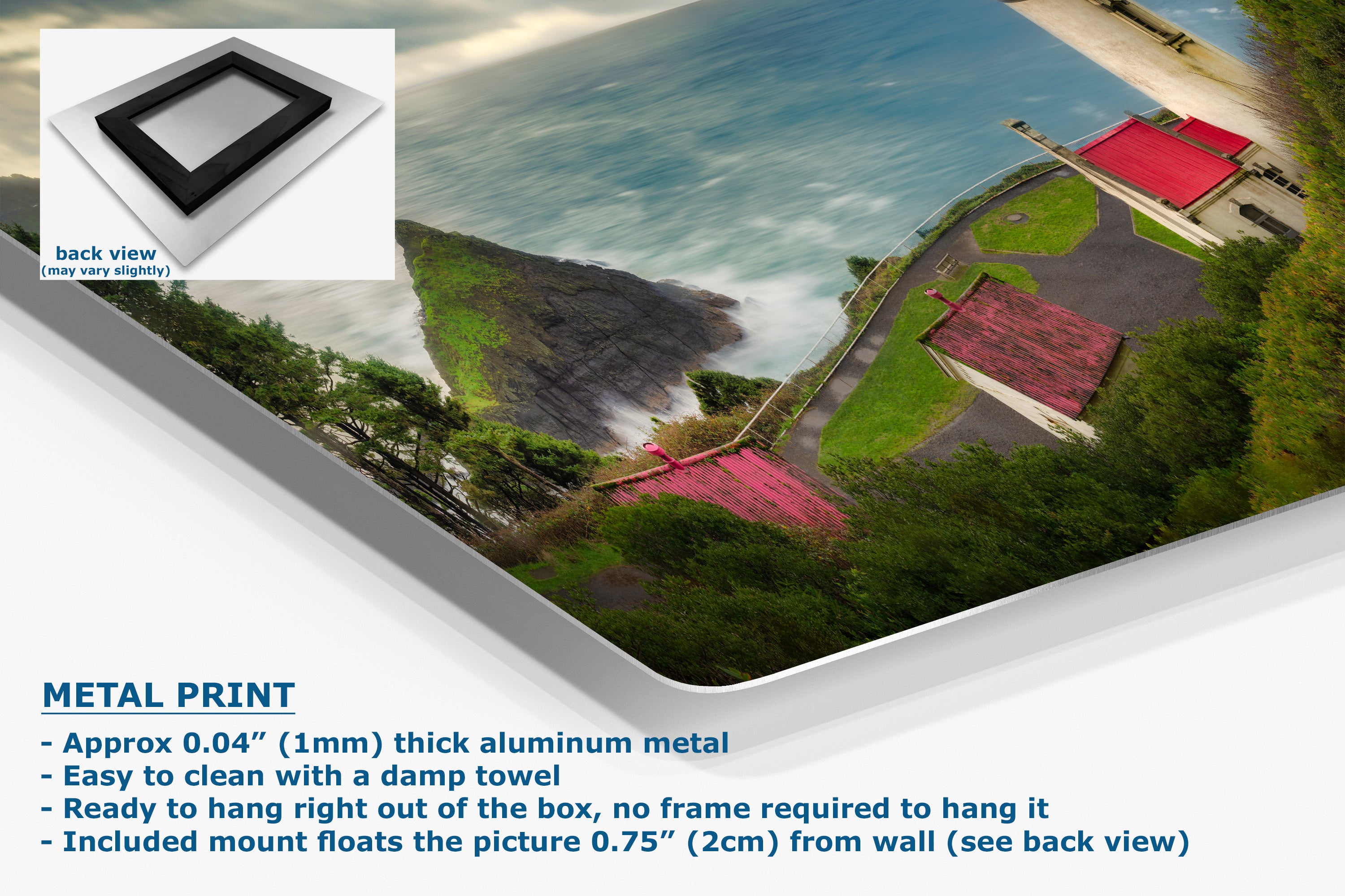 A metal wall art print showing an aerial coastal scene with blue water, green land, and red-roofed buildings, presented at an angle with a back-view inset and product text callouts.