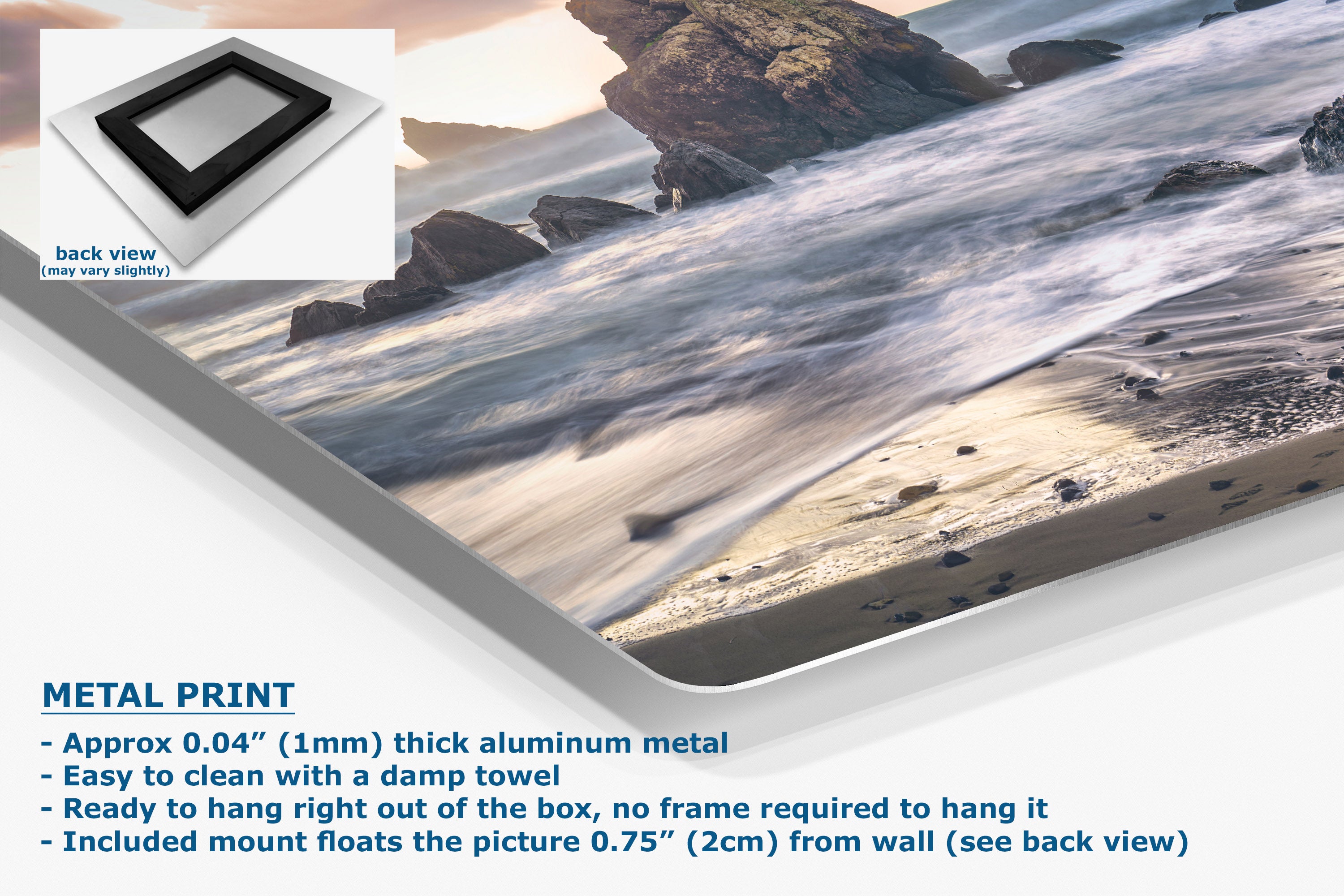 A metal wall art print showing a beach and rocky shoreline with ocean water, presented at an angle with product text and a small back-view inset. The text highlights the aluminum finish and mounting details.