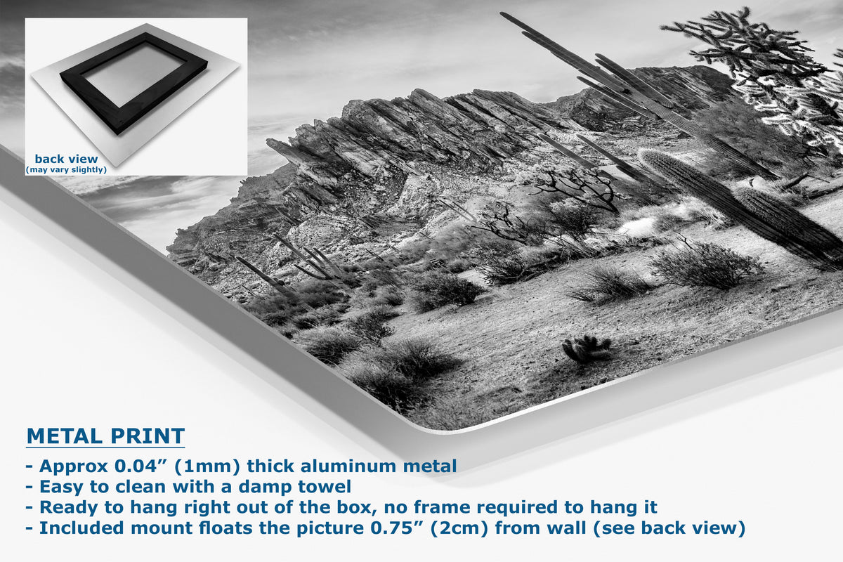 A corner view of an aluminum metal black-and-white desert landscape wall art print shown at an angle on a white background, with a small inset showing the back view of the frameless aluminum print. Text on the image describes the metal print features.