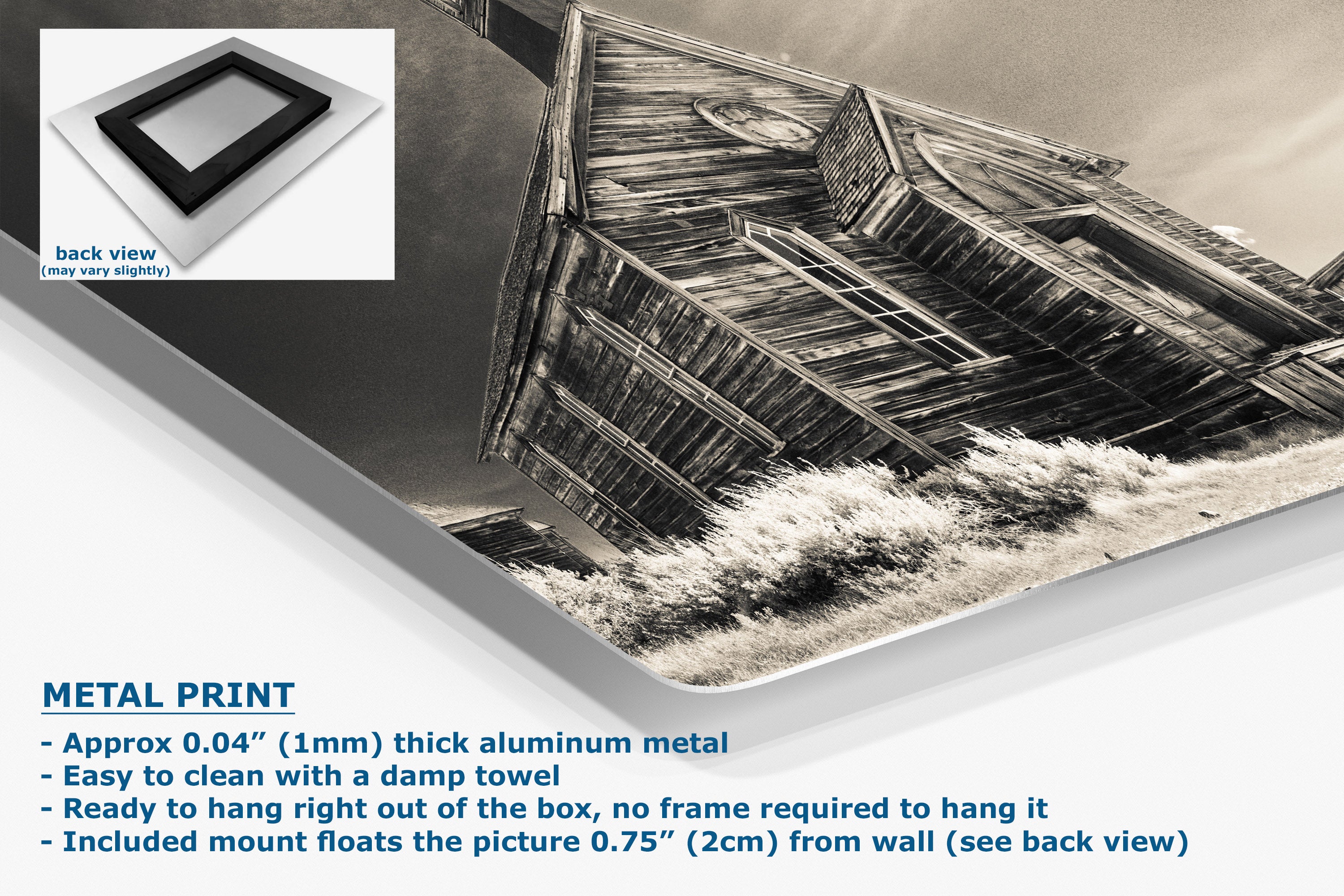 A corner view of an aluminum metal wall art print showing a black-and-white photograph of a weathered wooden church, displayed at an angle with product text and a small back-view inset on a white background.