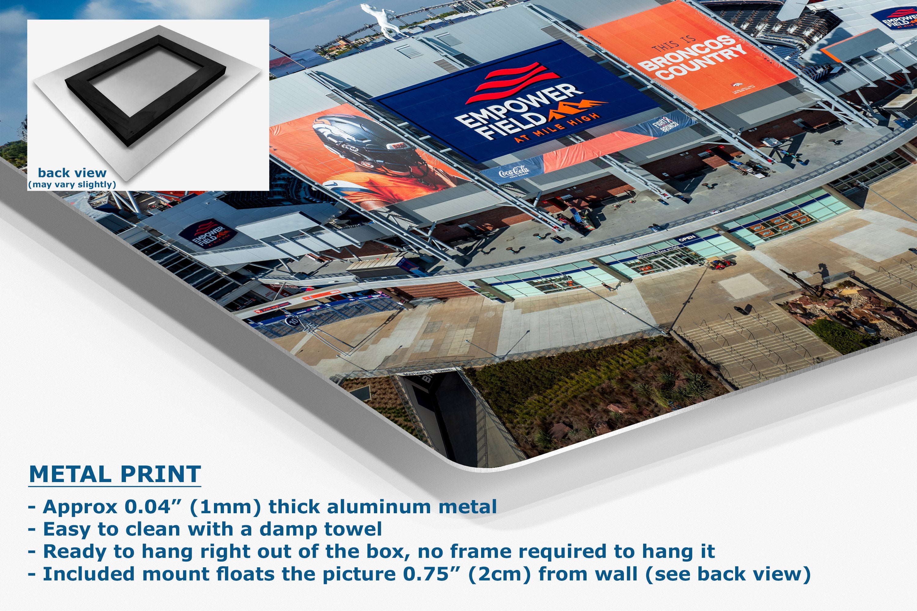 A corner view of an aluminum metal wall art print shown at an angle, with a small inset back view of the frameless panel. The print displays a large outdoor stadium scene with banners, including one that reads 'BRONCOS COUNTRY'.