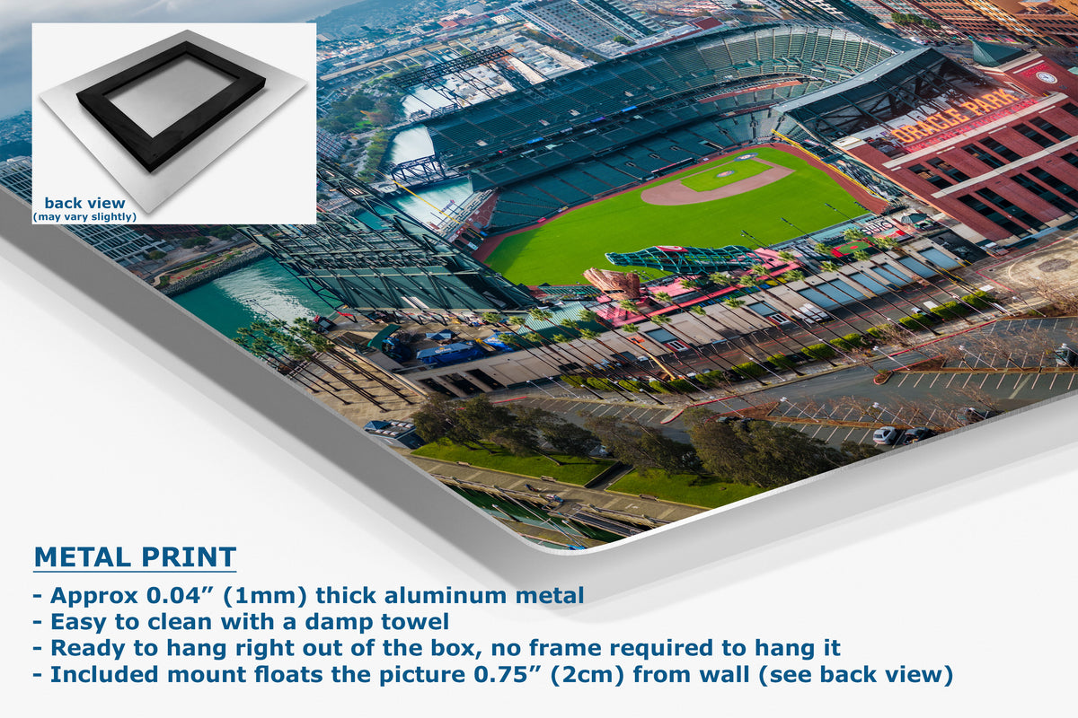 A corner view of an aluminum metal wall art print featuring an aerial photograph of a baseball stadium, shown at an angle with a white inset showing the back view and product text detailing its 0.04" thick aluminum finish.