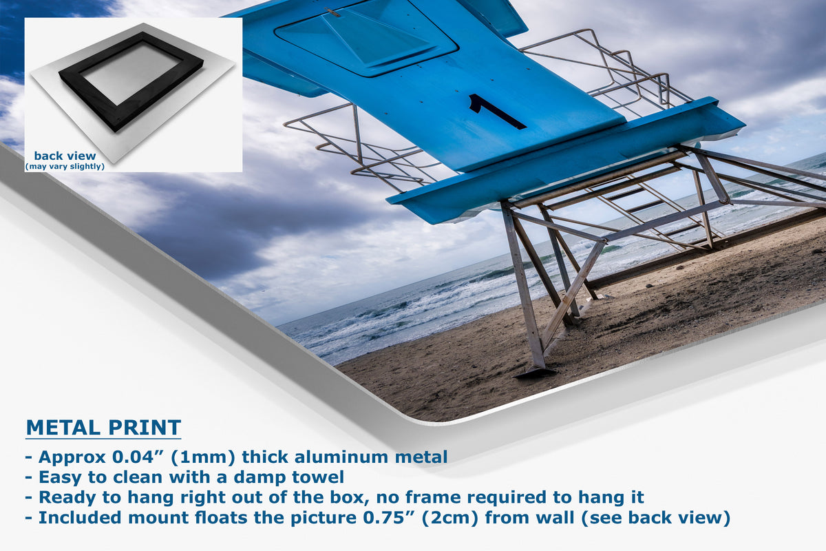 A metal print product shown on a white background with a beach scene photo printed on it. The image includes a small back-view inset, a blue lifeguard chair on a beach, and text describing the product.