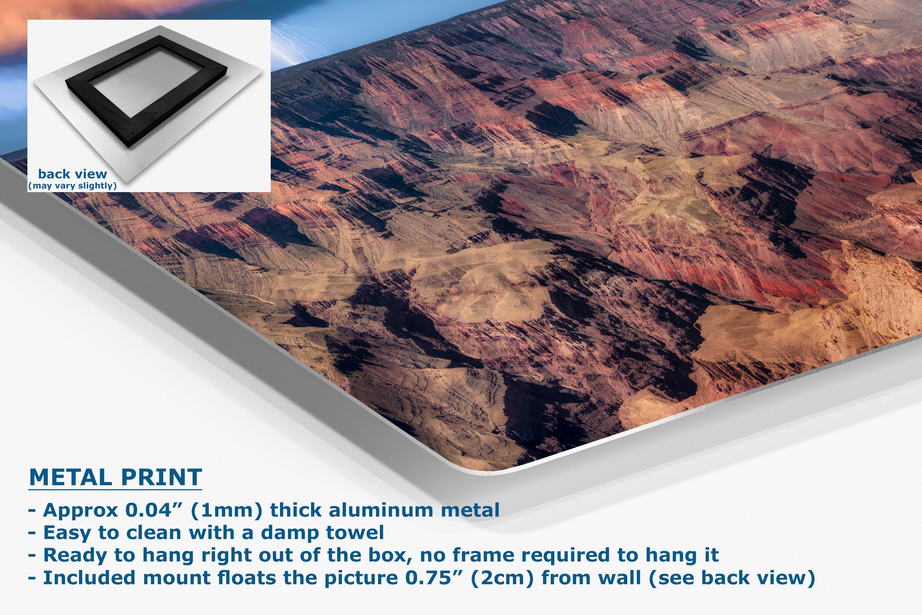 A large wall art print showing an aerial canyon landscape, presented at an angle with product text and a small back-view inset. The print appears to be made of aluminum metal, with blue text describing the metal print and mounting details.