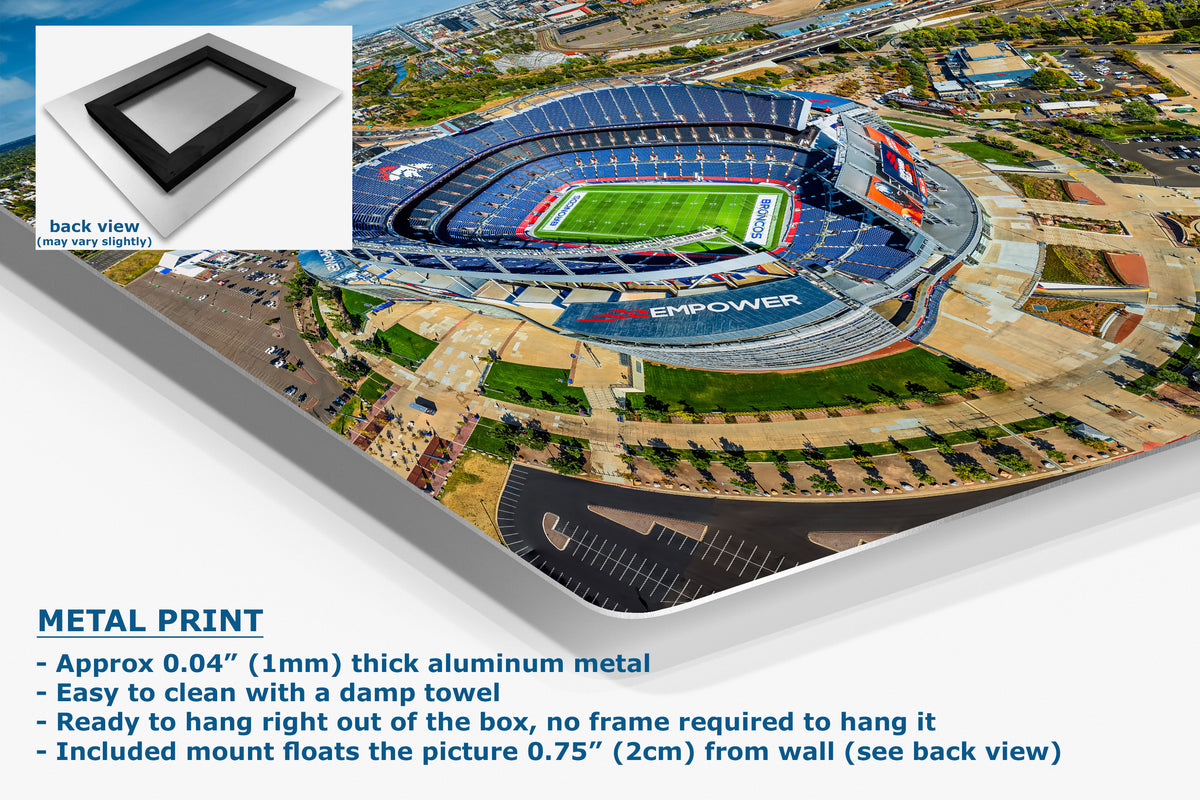 A corner view of an aluminum metal wall art print showing an aerial view of a blue stadium, with a small inset showing the back view of the frame mount. Text on the left describes the product as a metal print with aluminum construction, damp towel cleaning, and wall mounting.