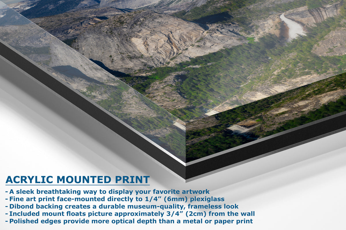 A corner view of an acrylic mounted art print showing a mountain landscape with a river, presented at an angle with descriptive text on a white background.