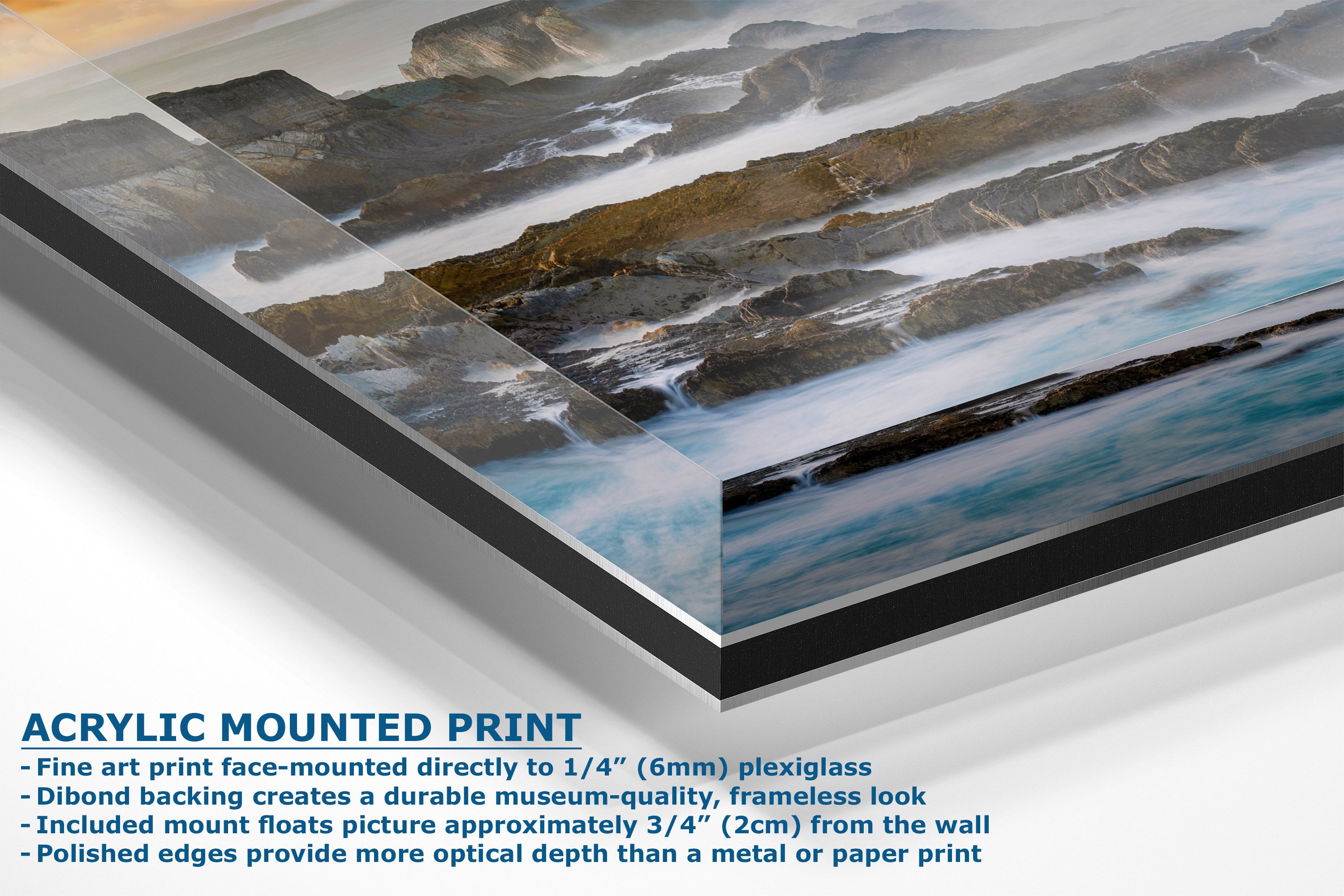 Acrylic mounted art print of a coastal landscape with rocky cliffs and flowing blue water, shown at an angle with descriptive text on a white background.