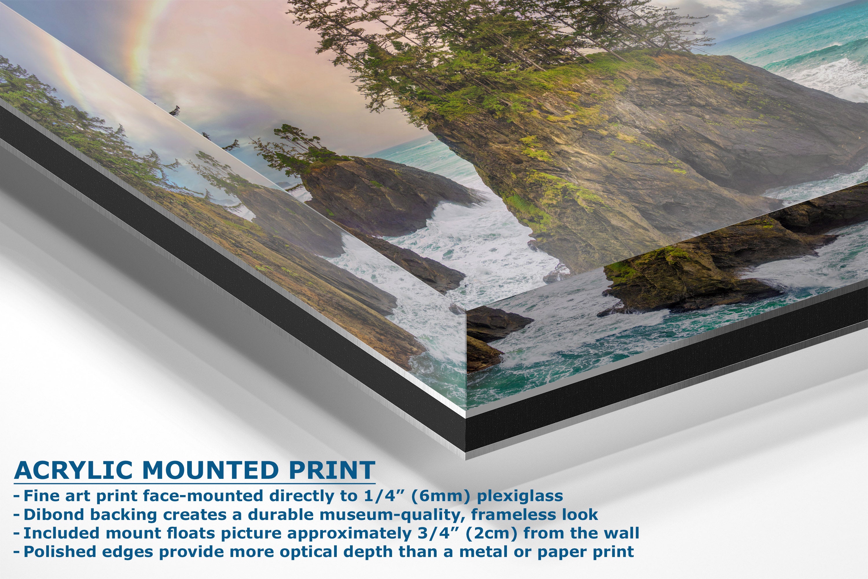 Acrylic mounted art print of a coastal landscape with cliffs, ocean waves, trees, and a rainbow, shown at an angle with descriptive text on a white background.