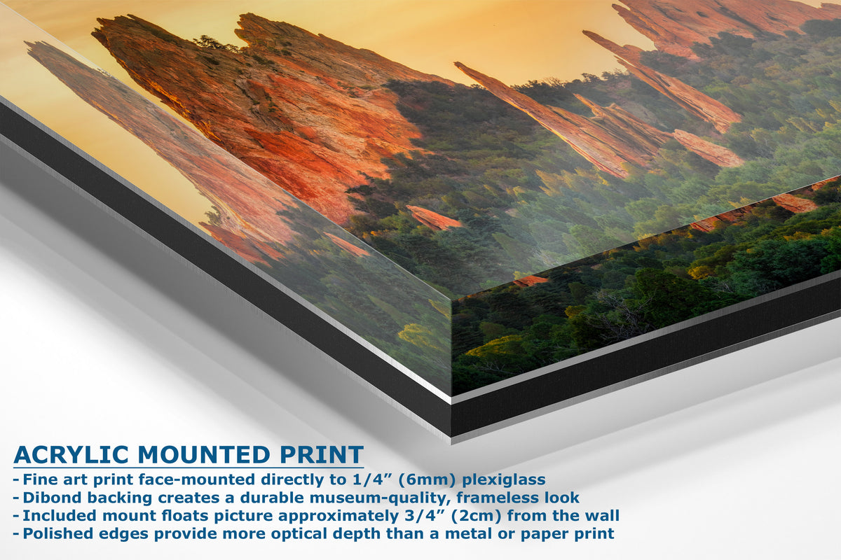 A corner view of an acrylic mounted art print of red rock formations in a desert landscape, shown at an angle with product specifications text below on a white background.