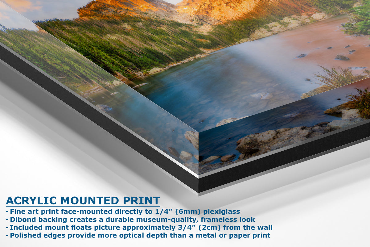 A corner view of an acrylic-mounted art print of a scenic landscape shown at an angle to show the depth of the product with descriptive text on a white background.