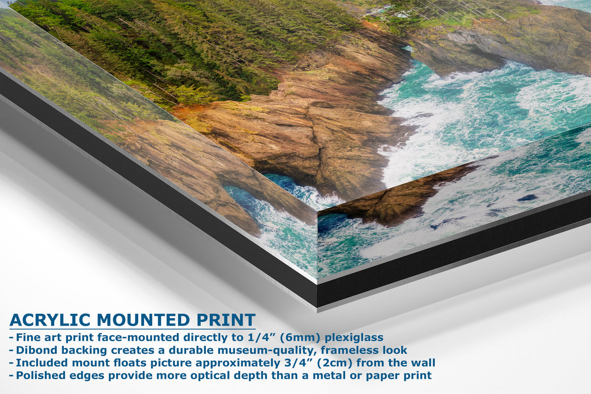 Acrylic mounted art print of a coastal landscape with rocky cliffs, green vegetation, and turquoise ocean water, shown at an angle with product details and text on a white background.