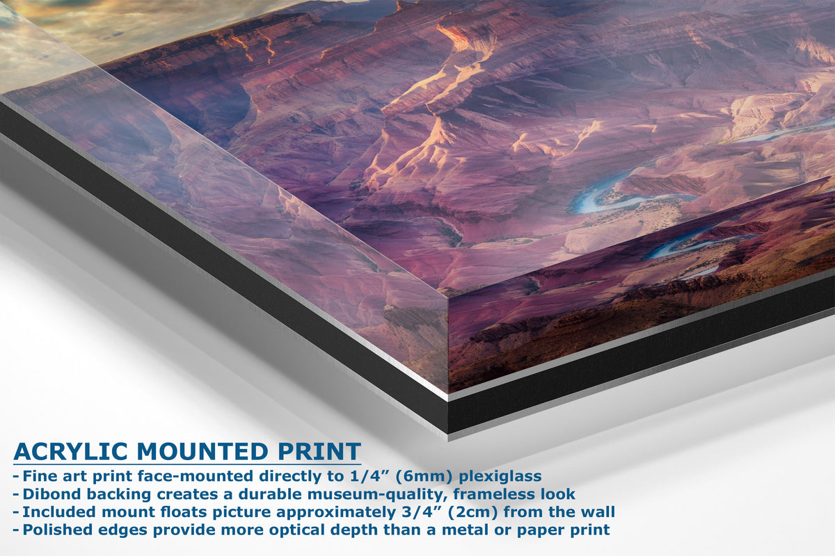 A corner view of an acrylic mounted art print of a desert canyon landscape, shown at an angle with descriptive text detailing its features on a white background.