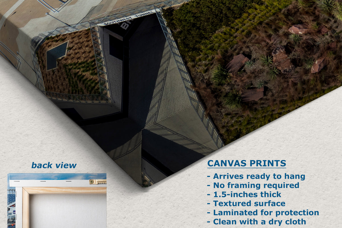 A corner view of a canvas print product shown at an angle on a light background, with text describing canvas prints and a small inset labeled back view. The print features a textured photographic scene with dark blue sky, brown earth, and green vegetation.