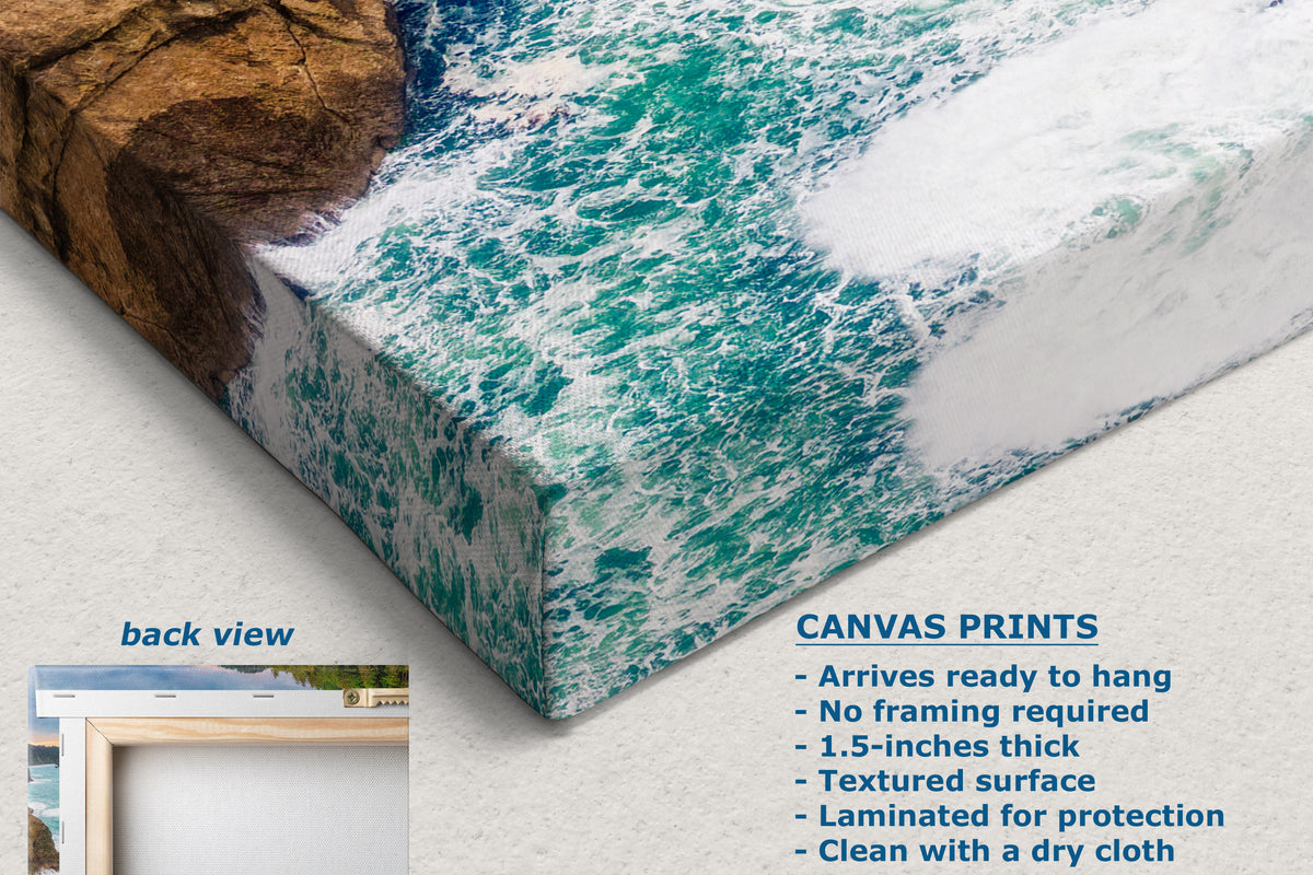 A corner of a canvas print showing a coastal ocean scene with turquoise waves and a rocky shore, displayed at an angle on a light background. Text on the image describes the canvas print features, and a small inset shows the back view with a frame.