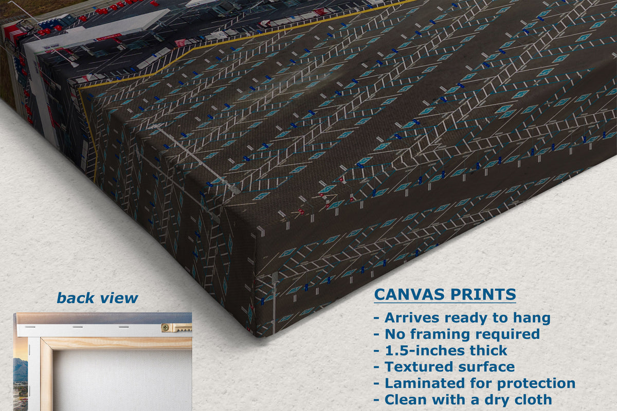 A corner view of a canvas wall hanging or panel shown at an angle on a light neutral background, with a small inset labeled 'back view' and text reading 'CANVAS PRINTS' listing features. The product has a dark brown base with repeating geometric line patterns in gray, white, and small blue accents.