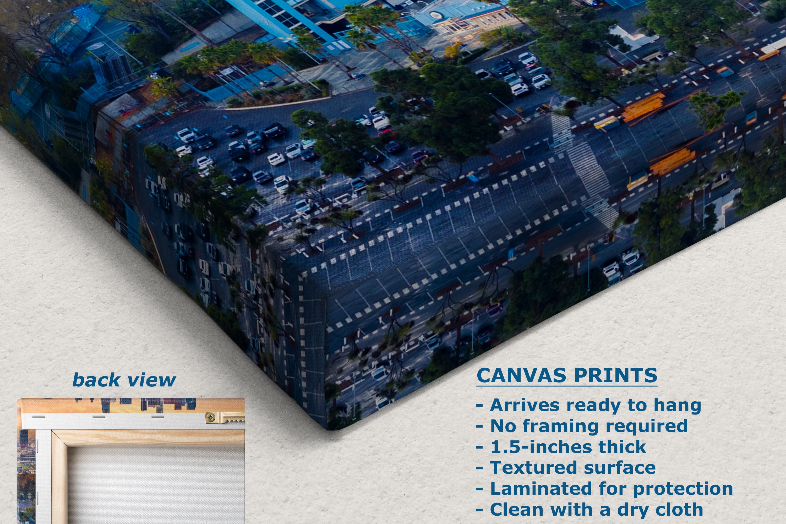Canvas wall art print shown at an angle with a city street scene printed across the surface. The image includes a small inset labeled 'back view' and text describing the print features: 'CANVAS PRINTS' with bullet points about arriving ready to hang, no framing required.