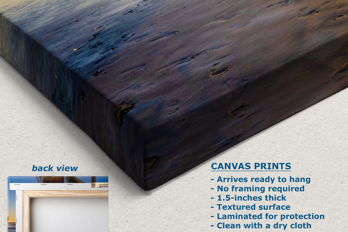 A canvas wall art print shown at an angle on a light neutral background, with text describing the print features and a small inset labeled back view showing a framed perspective. The artwork has a dark abstract painted surface with deep blue, navy, and black tones and some brownish textured areas.