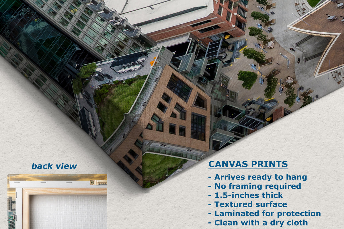 A promotional graphic for canvas wall art showing an aerial-style printed scene of modern buildings with green rooftops. The image includes text describing the print option and features, plus a small inset labeled back view showing a framed edge.