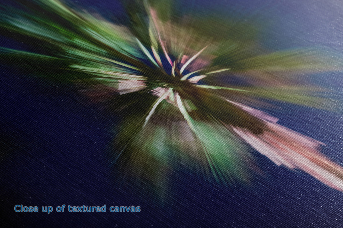 A close up view of the detail of a textured canvas wall art print that shows an abstract tree radiating brushstrokes in green, pink, white, and dark blue tones, with the text 'Close up of textured canvas' in the lower left corner.