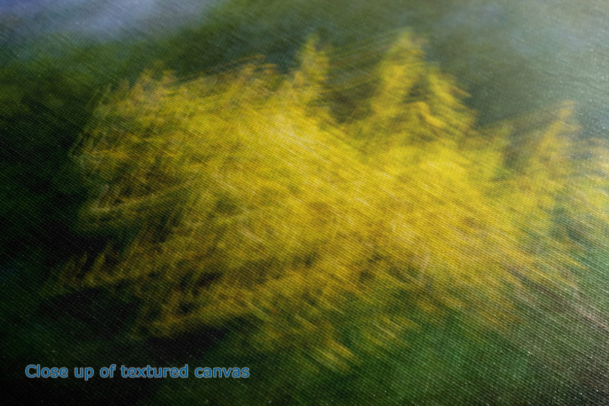 Close-up of a textured canvas painting depicting a yellow flowering bush or tree against a dark green and blue background, with blue text in the lower-left corner reading 'Close up of textured canvas'.