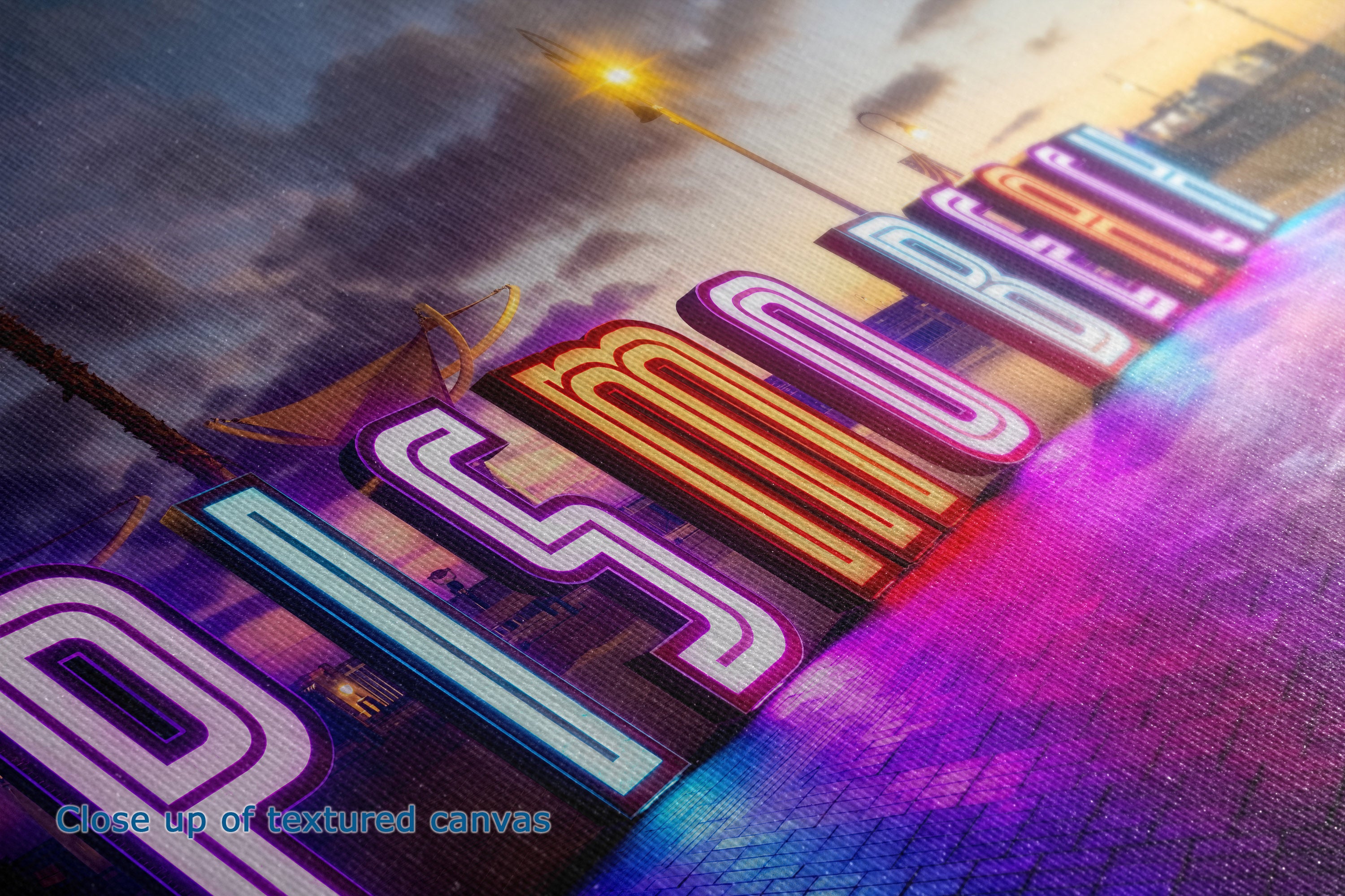A close-up of a colorful canvas print to show the detail of the texture with the artwork featuring stylized neon-style lettering over a city skyline at sunset, with a visible woven canvas texture and a small text overlay reading 'Close-up of textured canvas'.