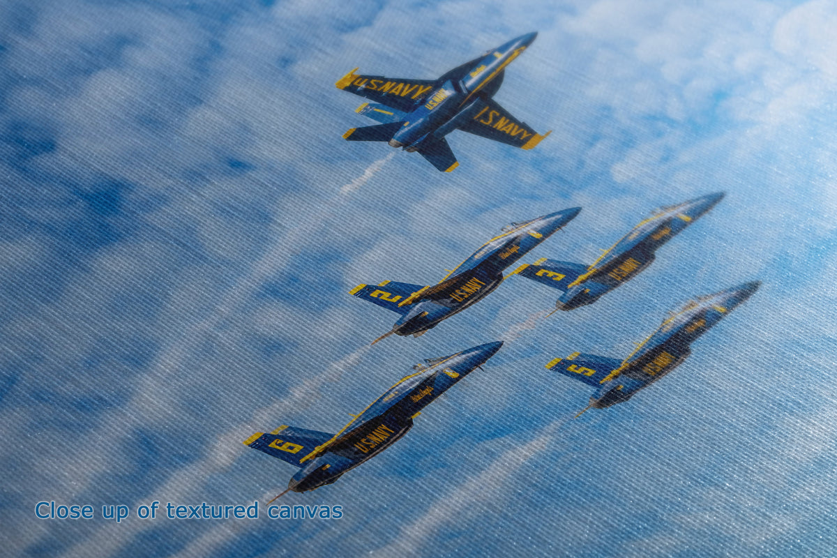 Close-up of the detail and texture of a canvas print depicting the Blue Angels jets flying in formation against a blue sky with white clouds. A text overlay in the bottom-left corner reads 'Close up of textured canvas'.