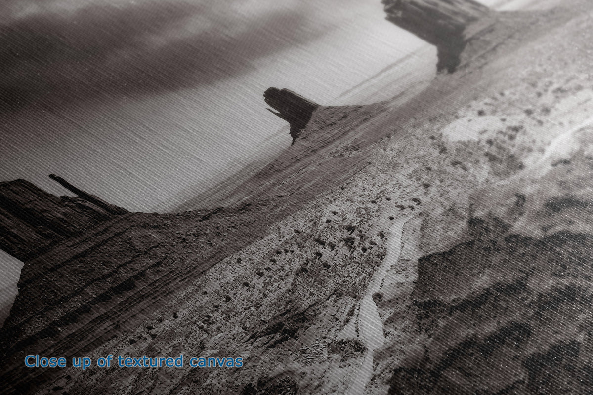 A close-up view of the detail and texture of a canvas wall art print of a black-and-white print of Monument Valley buttes.