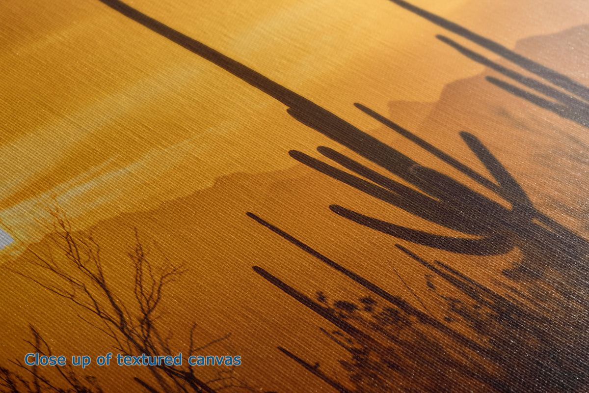 Close-up of a textured canvas print detail featuring a desert landscape with saguaro cacti and mountains under a warm golden-orange sky.