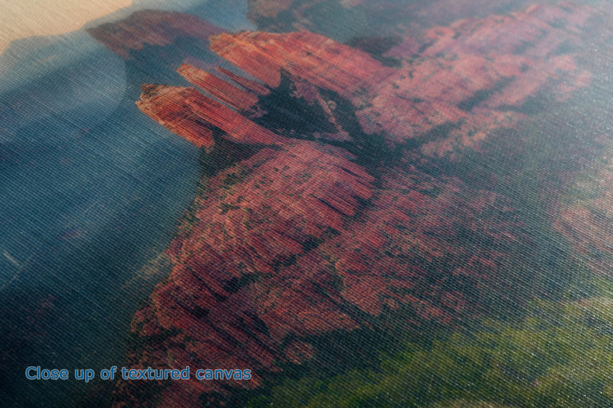 Close-up of the detail and texture of a  canvas print depicting a red rock canyon landscape with green vegetation, showing the fabric texture and a small blue text overlay reading 'Close up of textured canvas'.