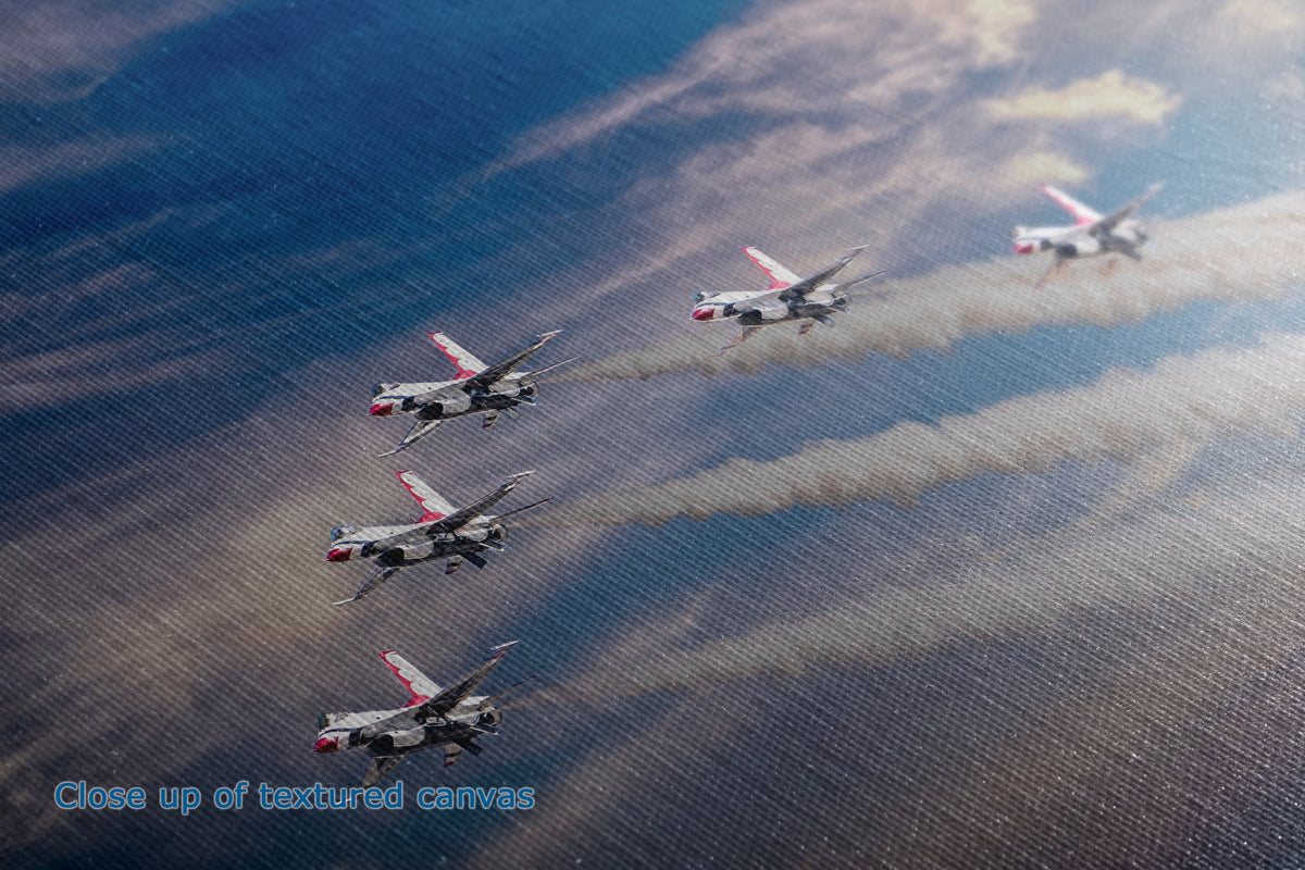 A close-up of the detail and texture of a canvas print depicting six military jets flying in formation, leaving smoke trails against a blue sky with clouds.