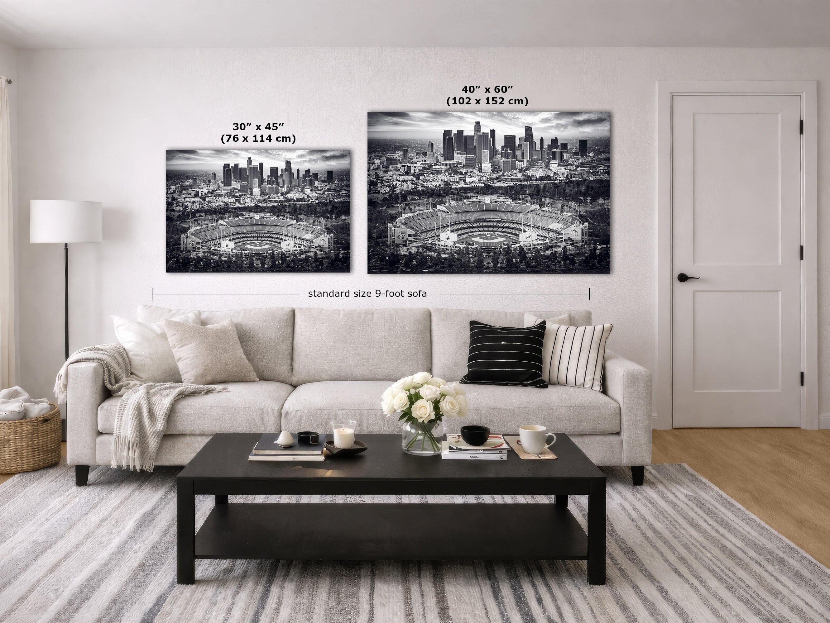 A staged living room showing two black and white Los Angeles Dodgers Stadium artwork wall art prints above a light sofa, with size labels overlaid: 30 x 45 in (76 x 114 cm) and 40 x 60 in (102 x 152 cm).
